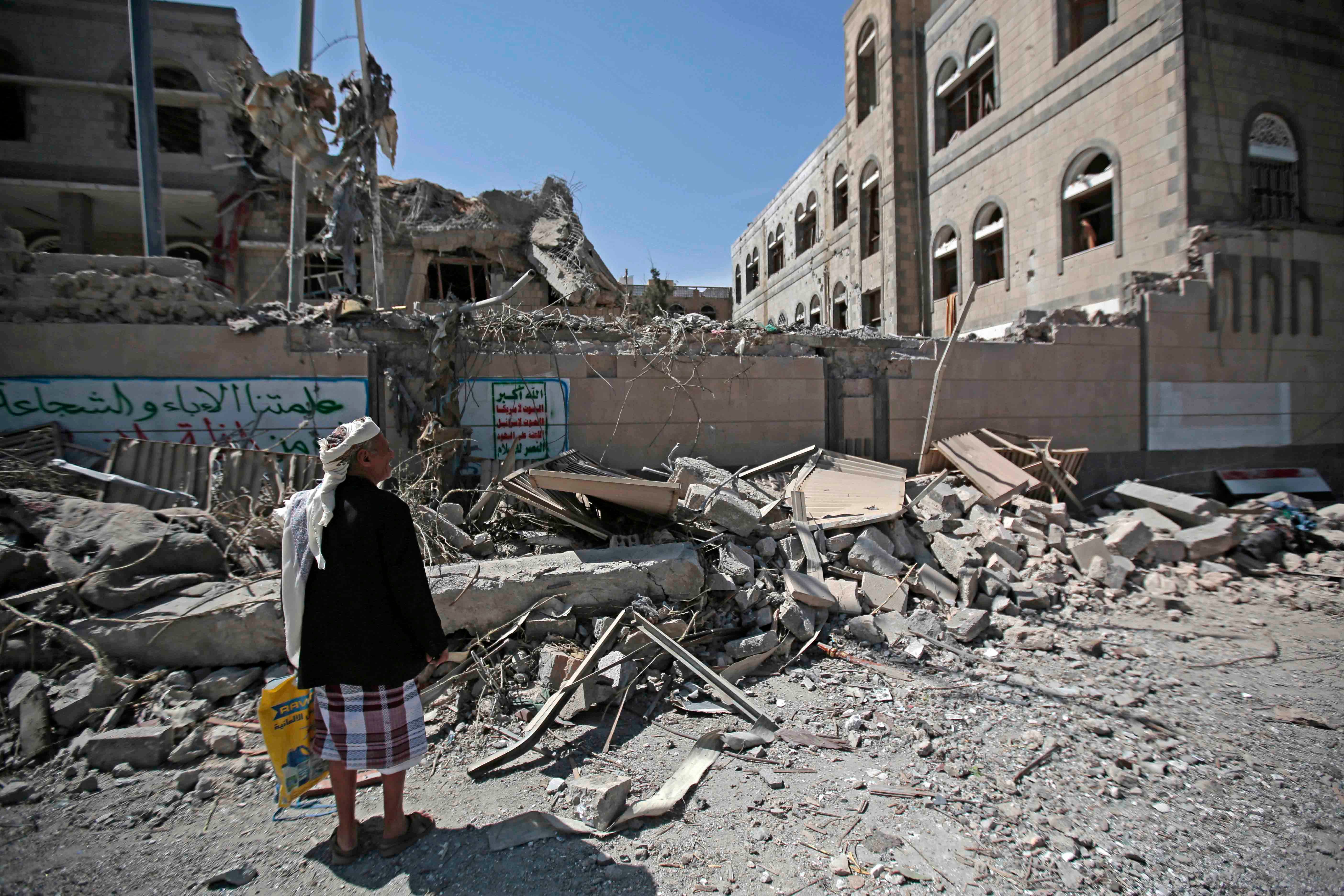 A man looks at damaged buildings after deadly airstrikes in Sanaa, Yemen, on May 7, 2018. 