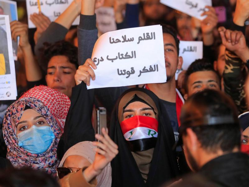 Woman holding up a sign during a protest