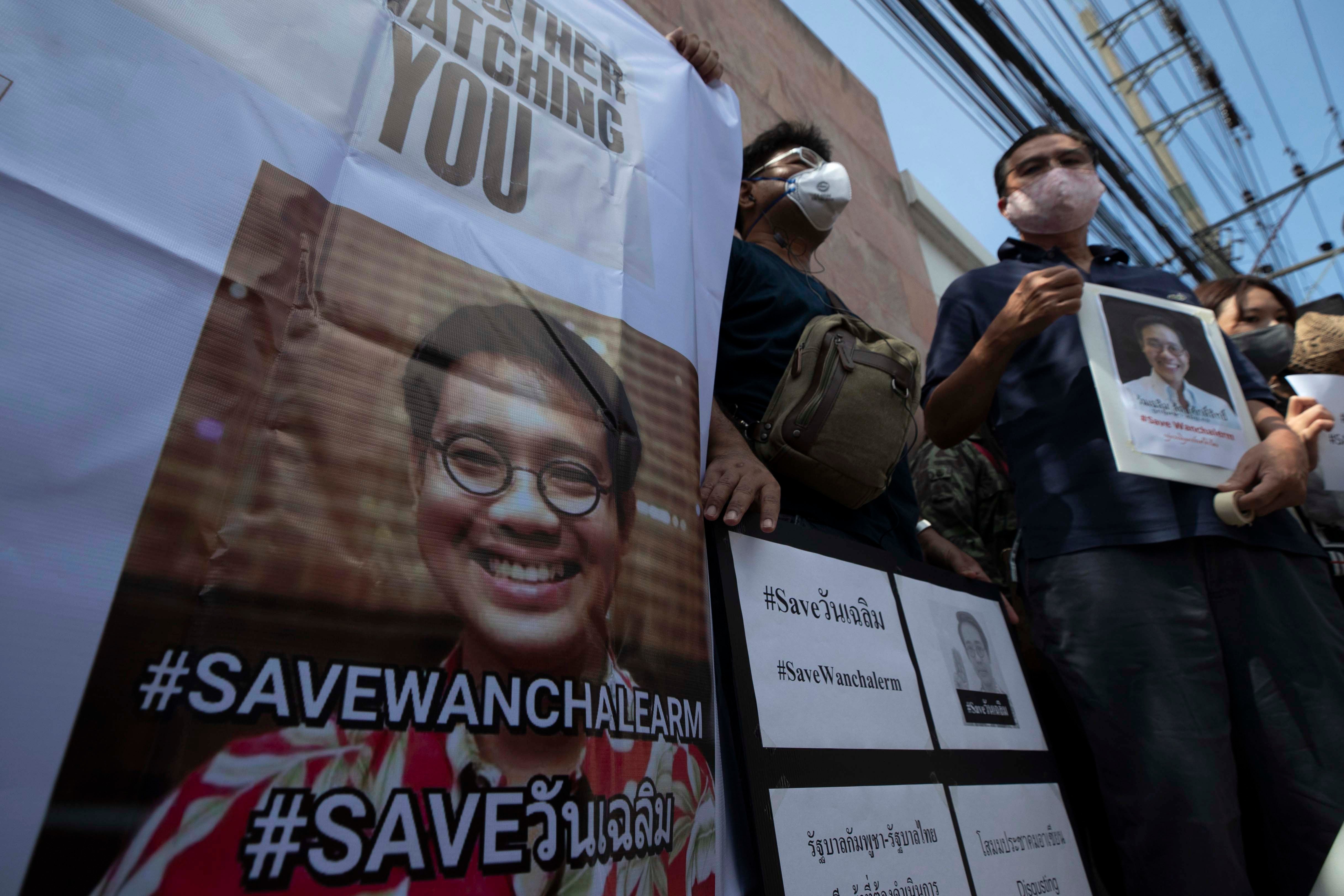 Demonstrators hold photos of Thai activist Wanchalearm Satsaksit and demand information on his whereabouts since his enforced disappearance, at a rally outside the Cambodian embassy in Bangkok, Thailand,  June 8, 2020. 