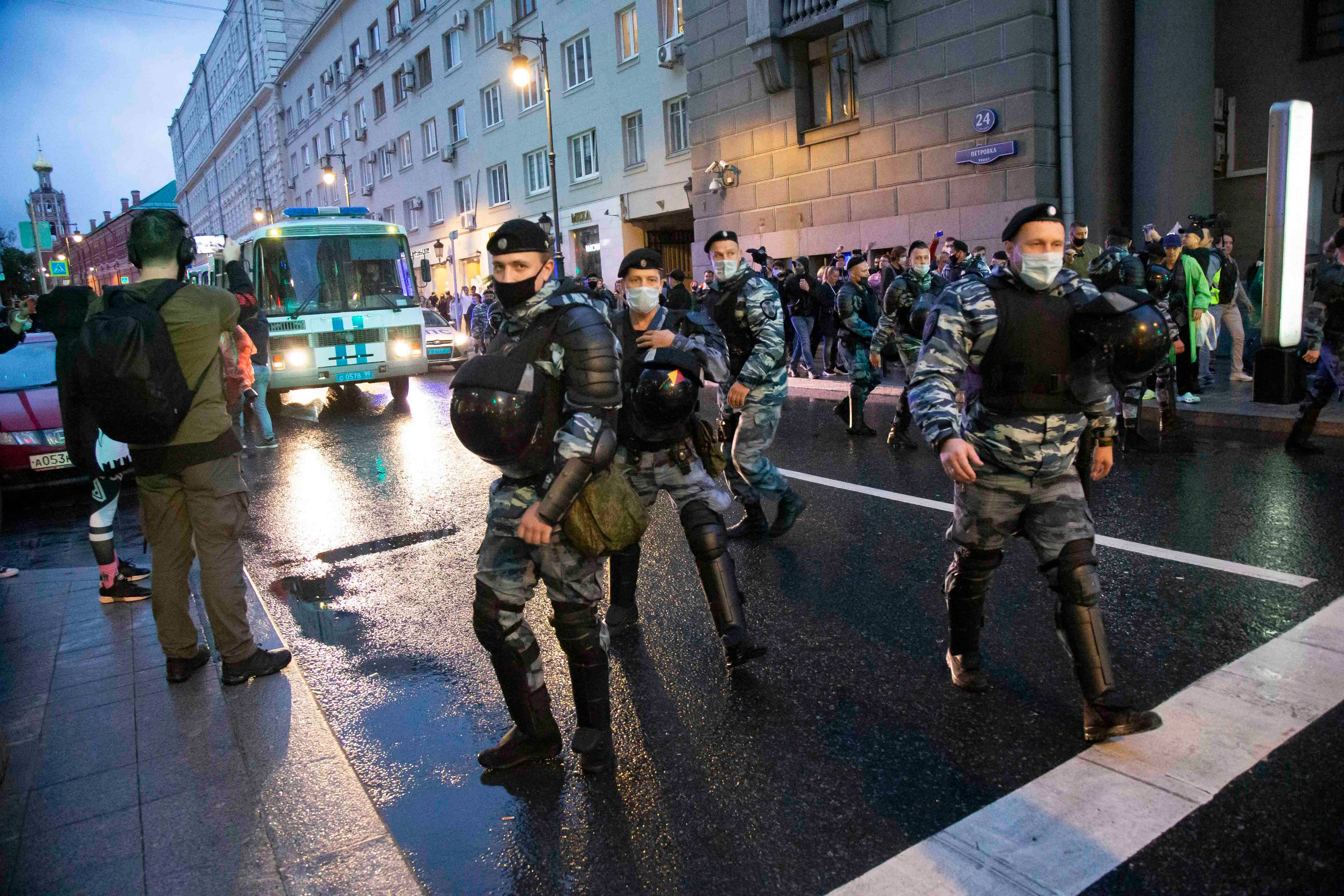 Police officers block the road during a rally objecting to the results of voting on Constitutional amendments in Moscow, Russia, Wednesday, July 15, 2020.