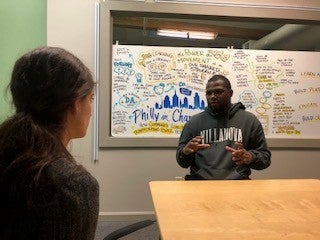 A man speaking to a woman at a table