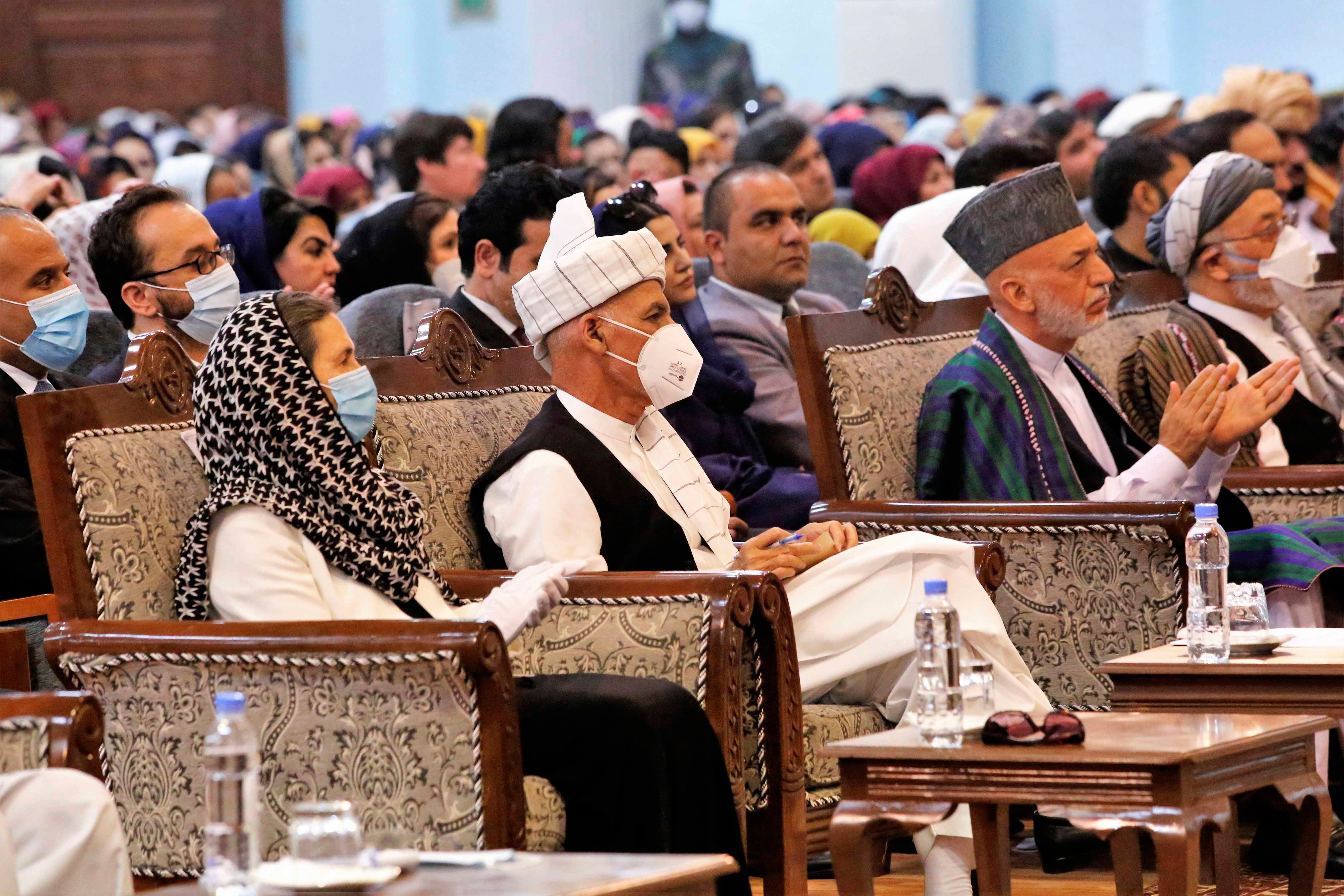 Afghan President Ashraf Ghani, center left, wears a protective face mask to help curb the spread of the coronavirus, on the last day of an Afghan Loya Jirga or traditional council, in Kabul, Afghanistan on Sunday, August 9, 2020. © 2020 AP Photos