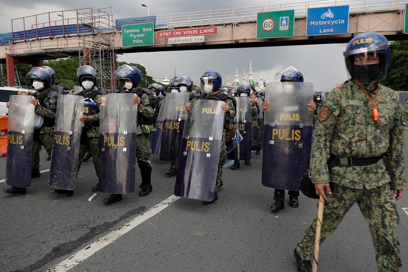 Police officers secure the road leading to the House of Representatives where President Rodrigo Duterte will deliver his 5th State of the Nation Address (SONA) on Monday, July 27, 2020 in Metro Manila, Philippines.