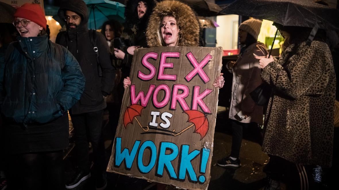 People take part in an International Women's Day march in London, England, against criminalization of sex work