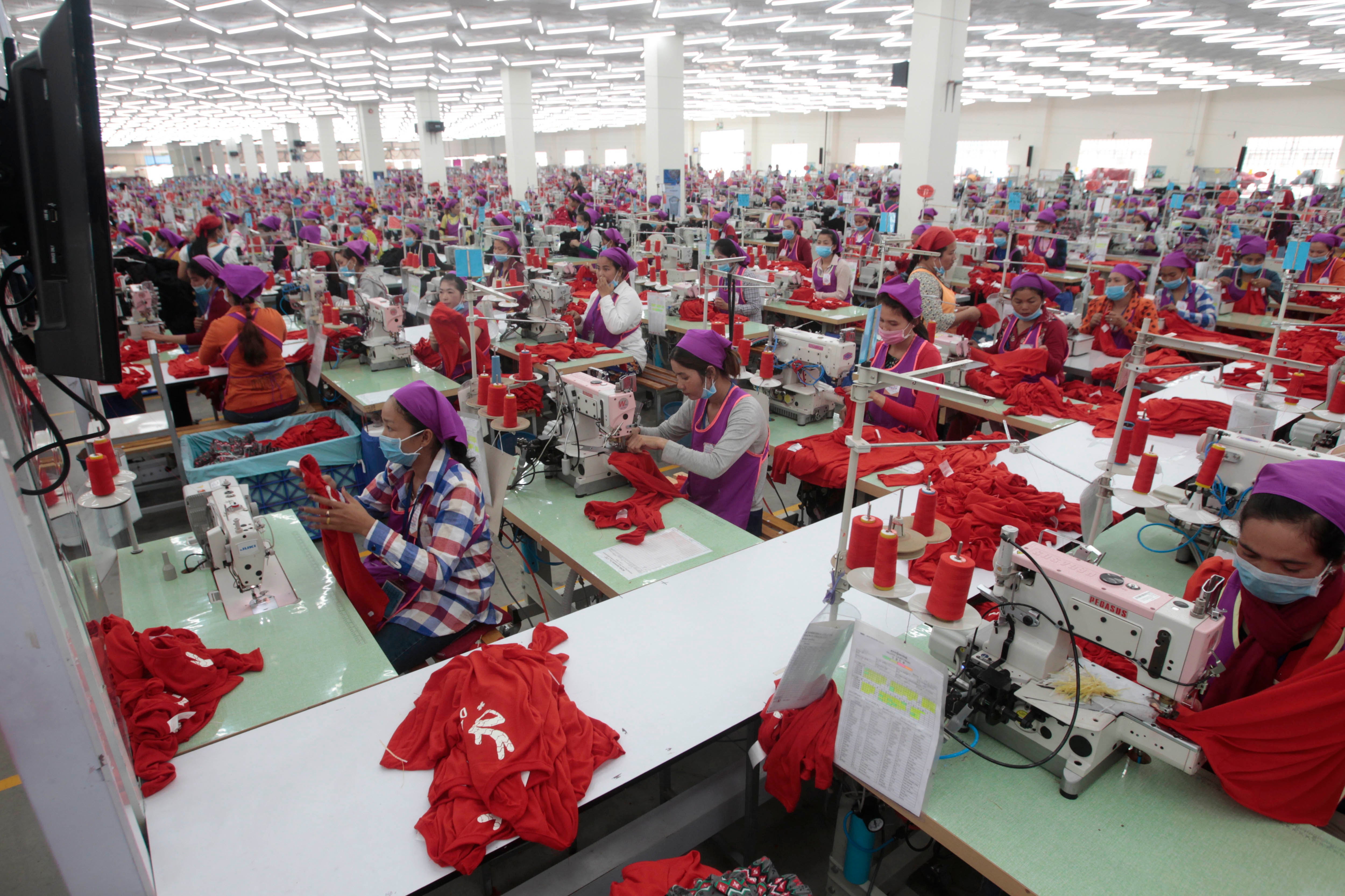 Garment workers in a factory await a visit by Prime Minister Hun Sen outside of Phnom Penh, Cambodia, August 30, 2017.
