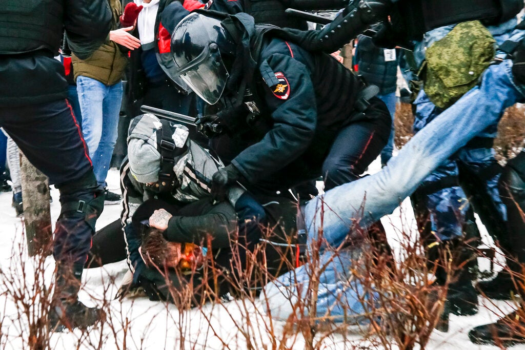 Riot police detain a demonstrator with a bloody face during a protest against the jailing of opposition leader Alexei Navalny in Pushkin Square, Moscow, Russia, Saturday, January 23, 2021. 