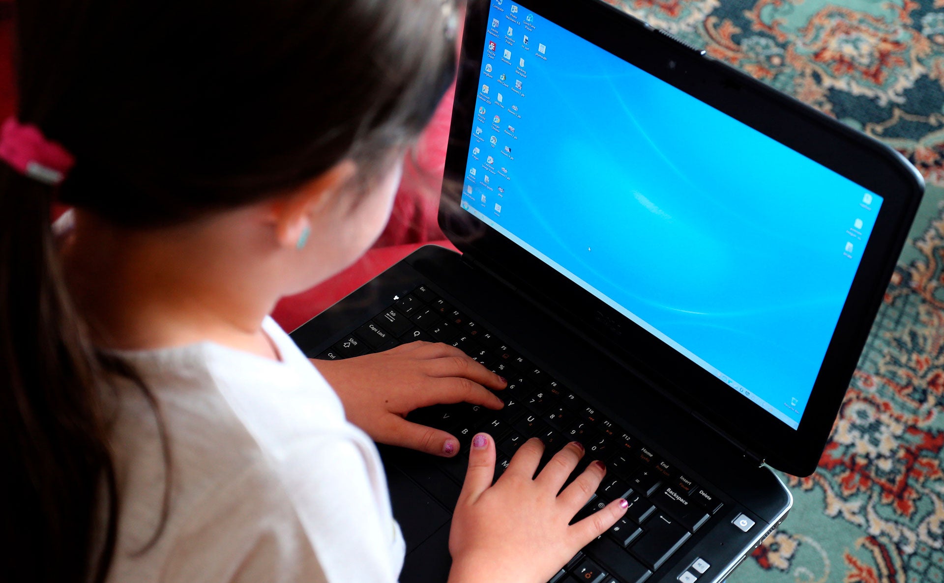 A student uses a laptop for schoolwork while participating in remote learning, September 7, 2020.