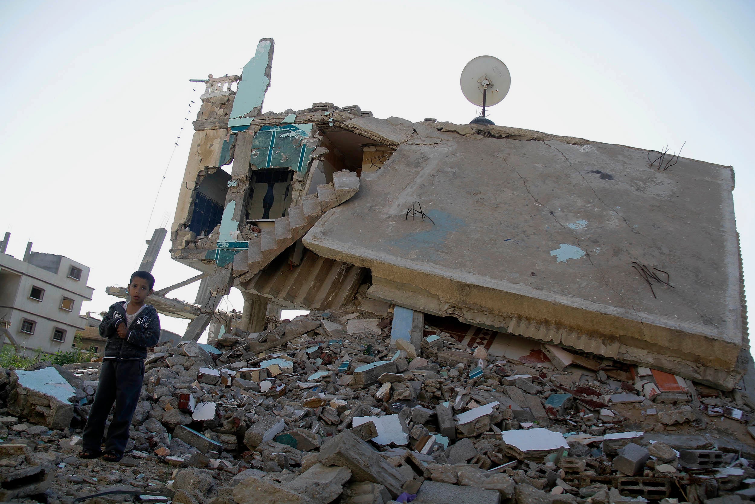 A boy stands on the debris of a building destroyed by the Egyptian army on the Egyptian side of the town of Rafah, Egypt, on November 6, 2014, near the start  of the conflict in northern Sinai. 