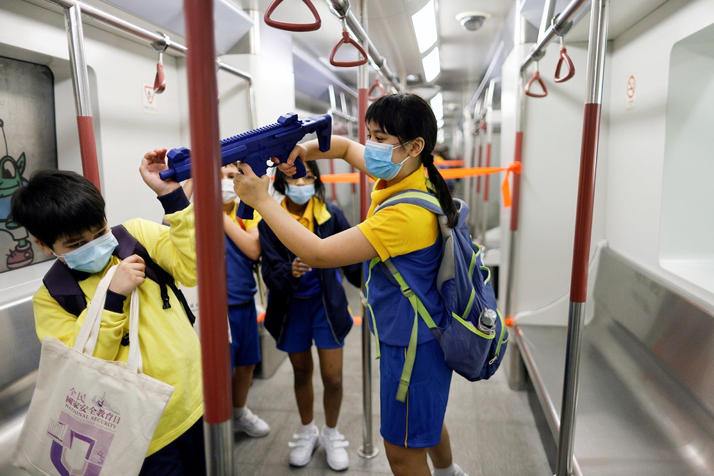 During Hong Kong’s first “National Security Education Day,” a&nbsp;child&nbsp;is given&nbsp;a mock submachine gun&nbsp;to play&nbsp;with&nbsp;at a model Mass Transit Railway (MTR) station at Hong Kong Police College,&nbsp;on April 15, 2021.