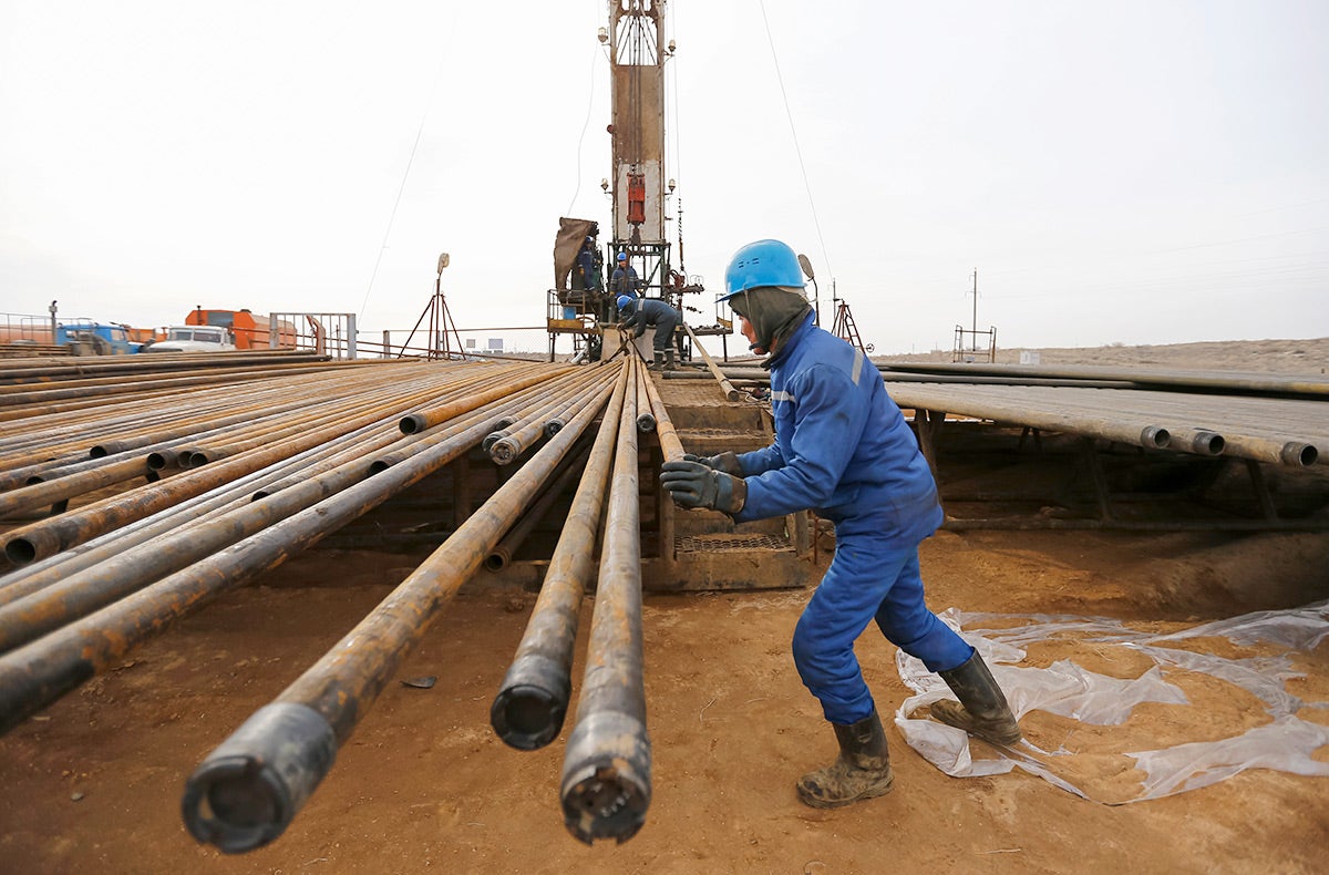 A worker prepares pipes to service an oil well on oil fields operated by a subsidiary of the KazMunayGas Exploration Production JSC in Kyzylorda region, southern Kazakhstan on January 21, 2016.