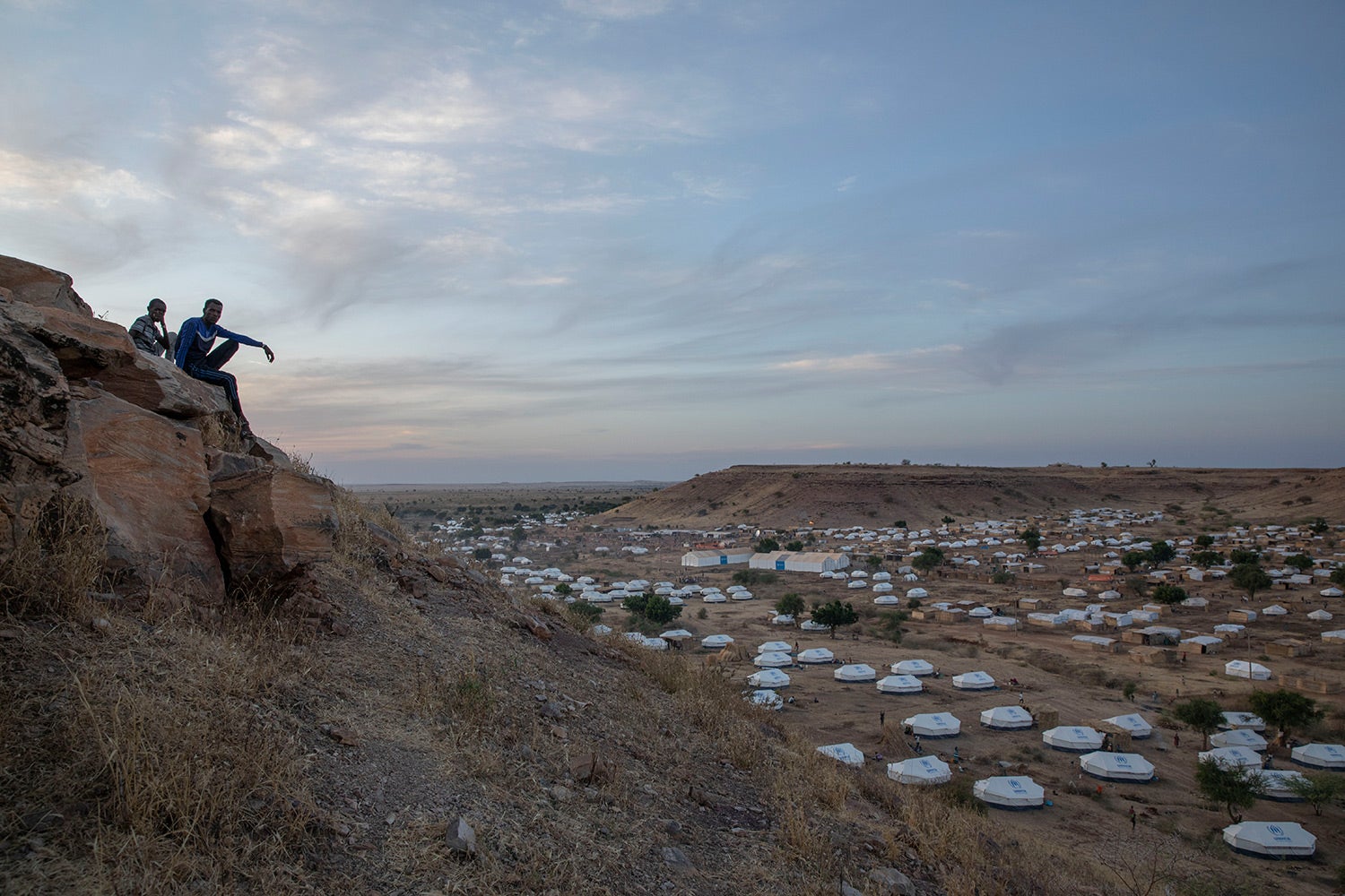 Tigrayan men sit atop a hill overlooking part of the Umm Rakouba refugee camp, in Qadarif, eastern Sudan, on December 14, 2020. 