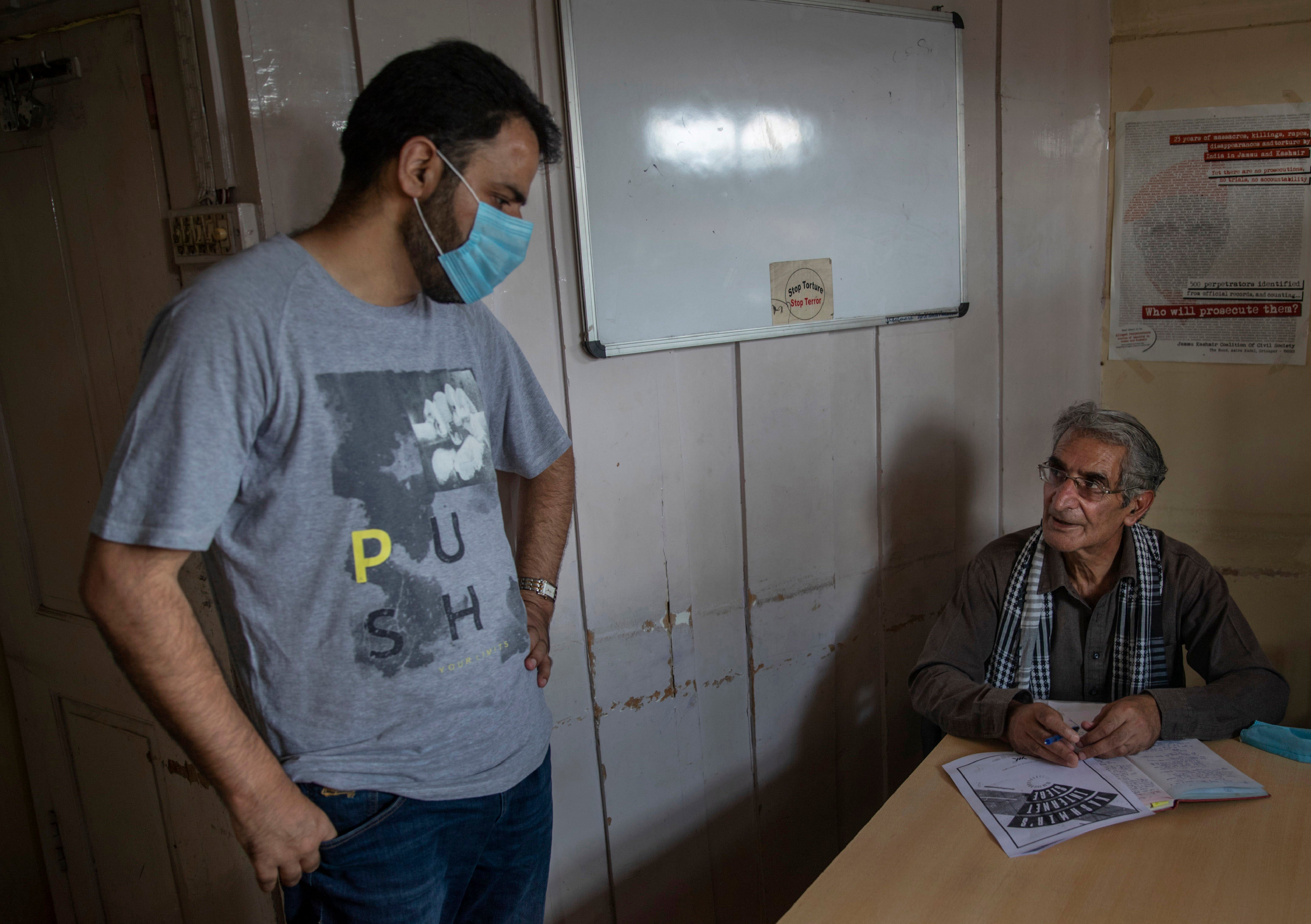 Khurram Parvez, a prominent human rights activist, left, in the office of the Jammu and Kashmir Coalition of Civil Society in Srinagar, India, August 25, 2020. 