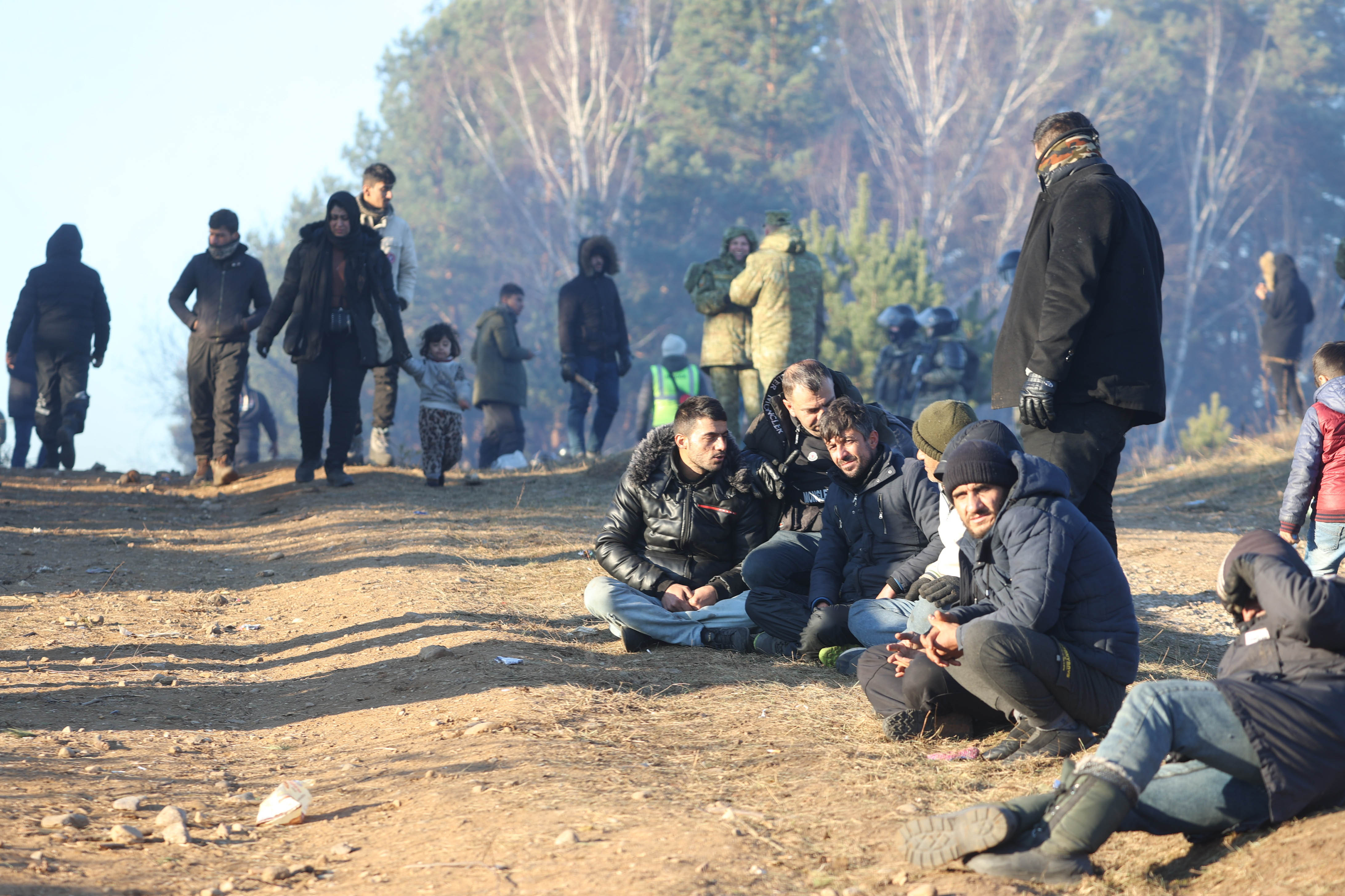 A group of men seated on the ground 