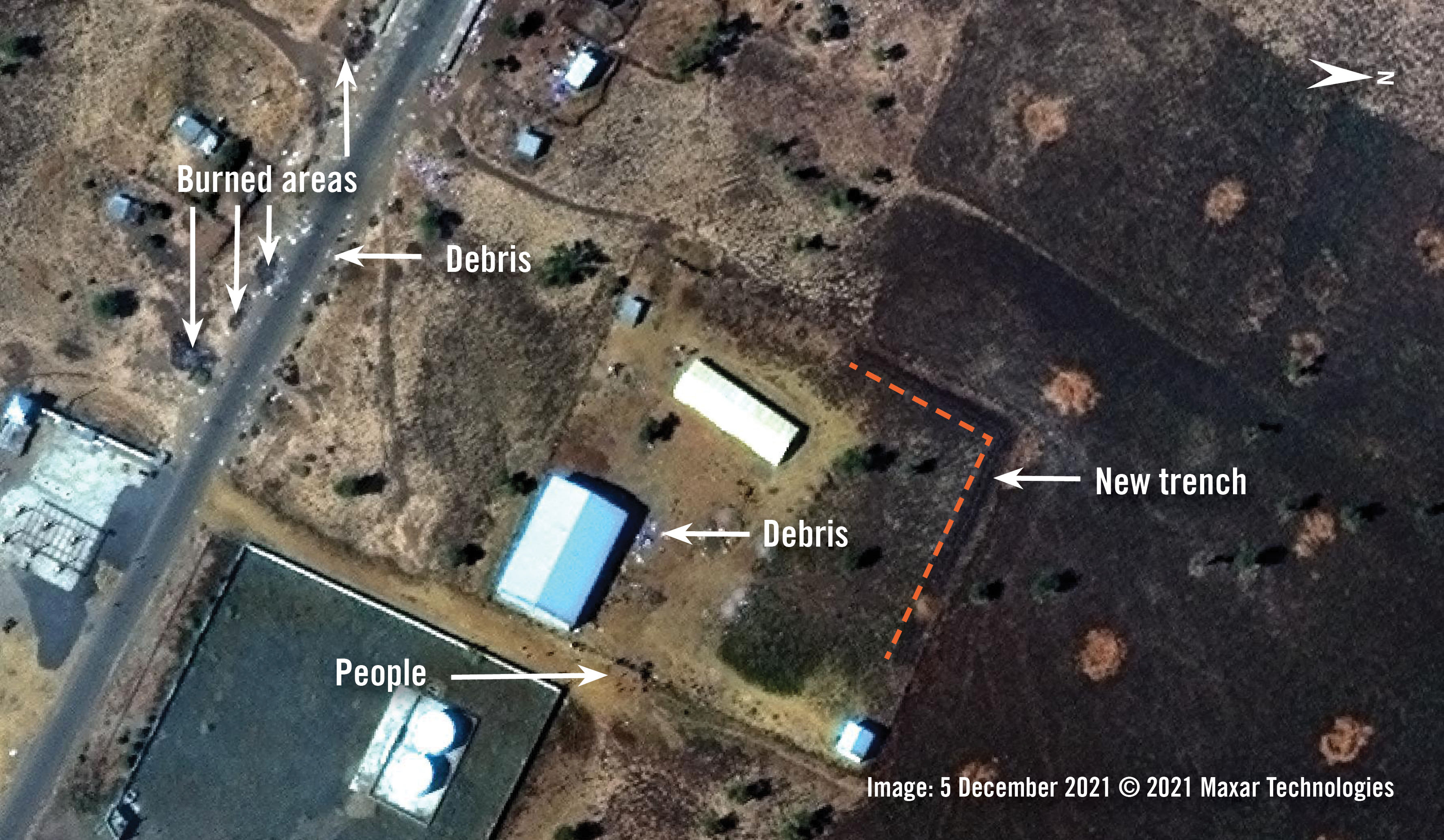 Analysis of satellite image collected on 5 December 2021 of the eastern outskirts of Adebai town. People and debris are visible around a large warehouse, near the Enda Roto petrol station. Burned areas and debris are visible by the main road. 