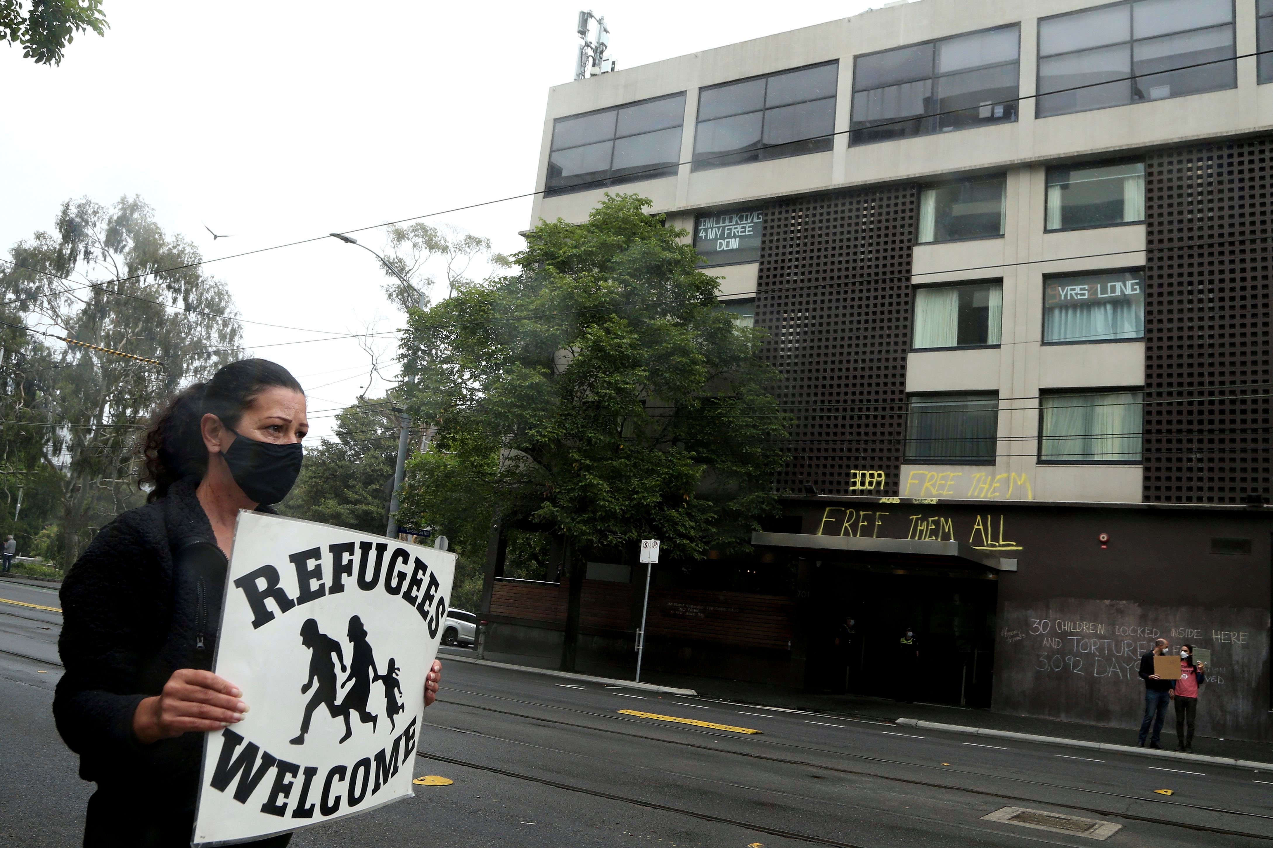 A protester outside the Park Hotel calling for the release of refugees being detained inside the hotel in Melbourne