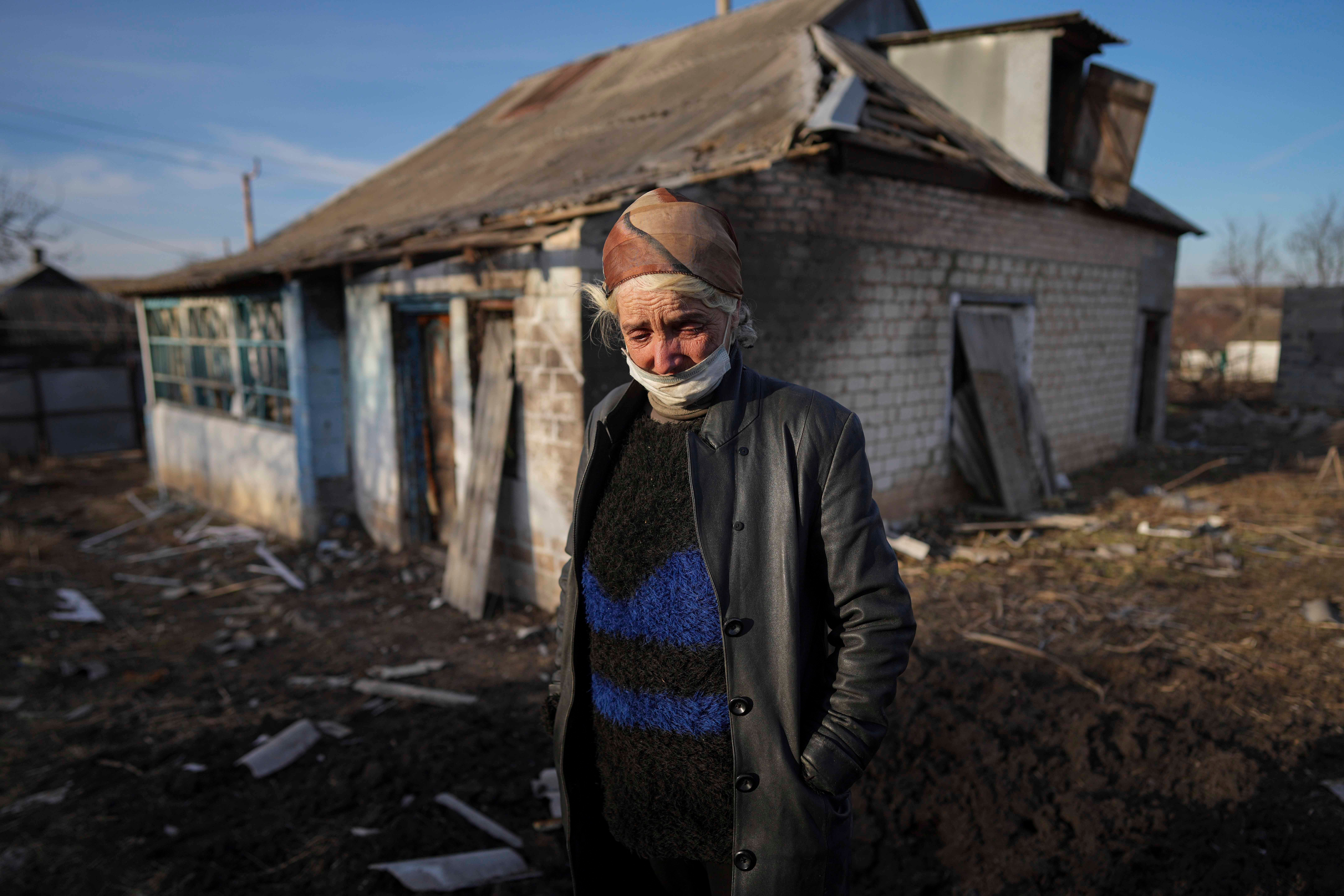Tetyana Tomenko in front of her house, which was damaged during shelling in Novognativka, eastern Ukraine, February 20, 2022.