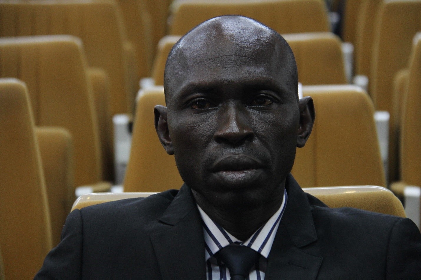 A man sits facing the camera