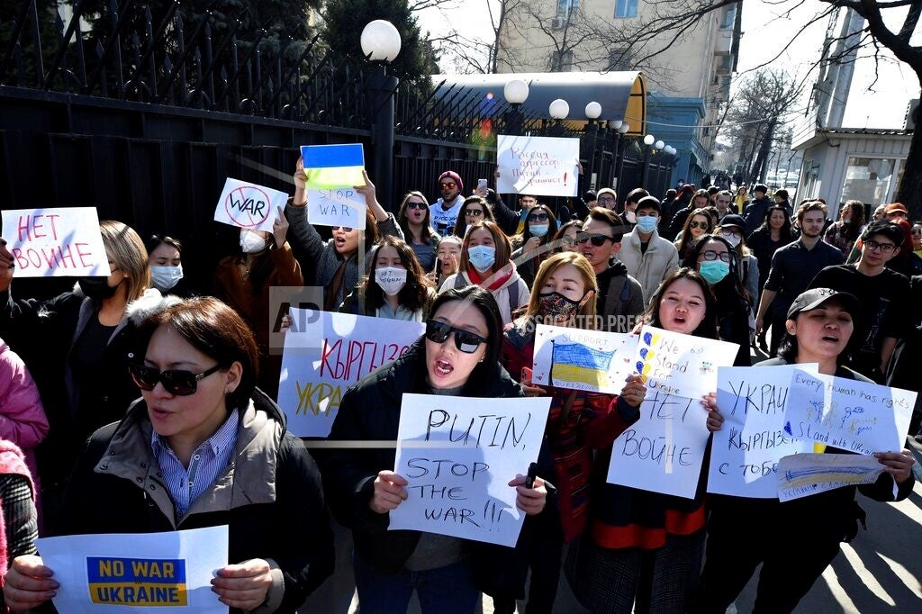 Demonstrators hold anti-war posters during an action against Russia’s attack on Ukraine near the Russian Embassy in Bishkek, Kyrgyzstan, February 28, 2022.