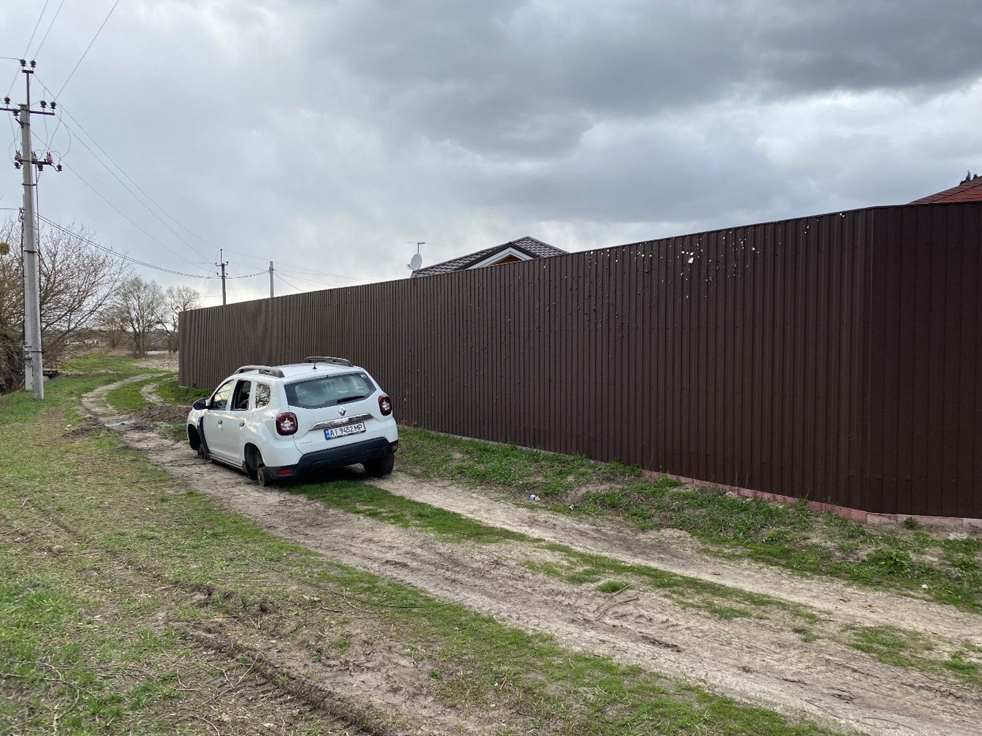 Russian forces in Hostomel opened fire on this civilian vehicle in which Yurii Prylypko, Hostomel’s mayor, Yurii Shturma, Taras, and Ivan Zaria were driving on the afternoon of March 3, 2022. Prylypko and Zaria were killed.