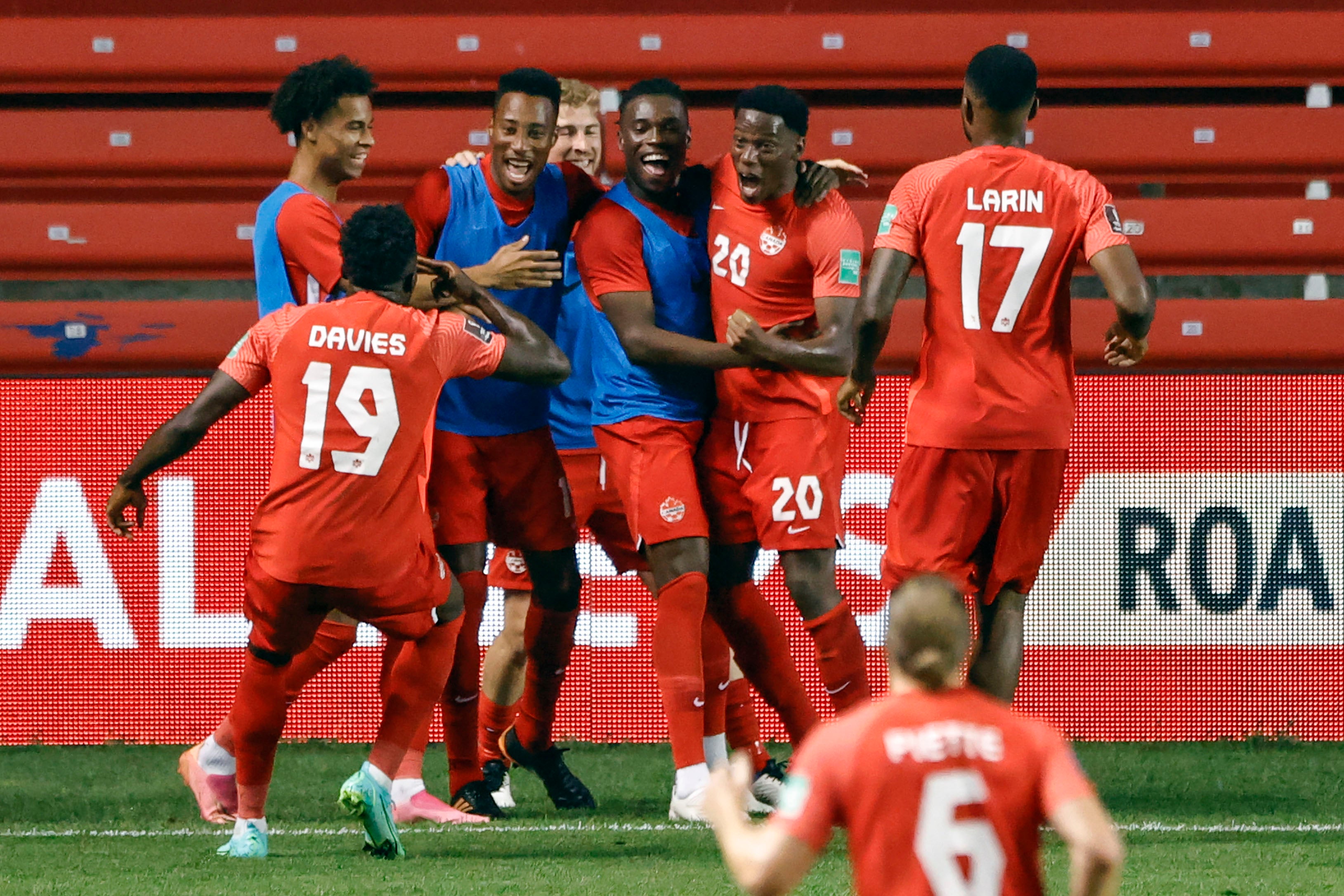 Soccer team celebrates after scoring a goal