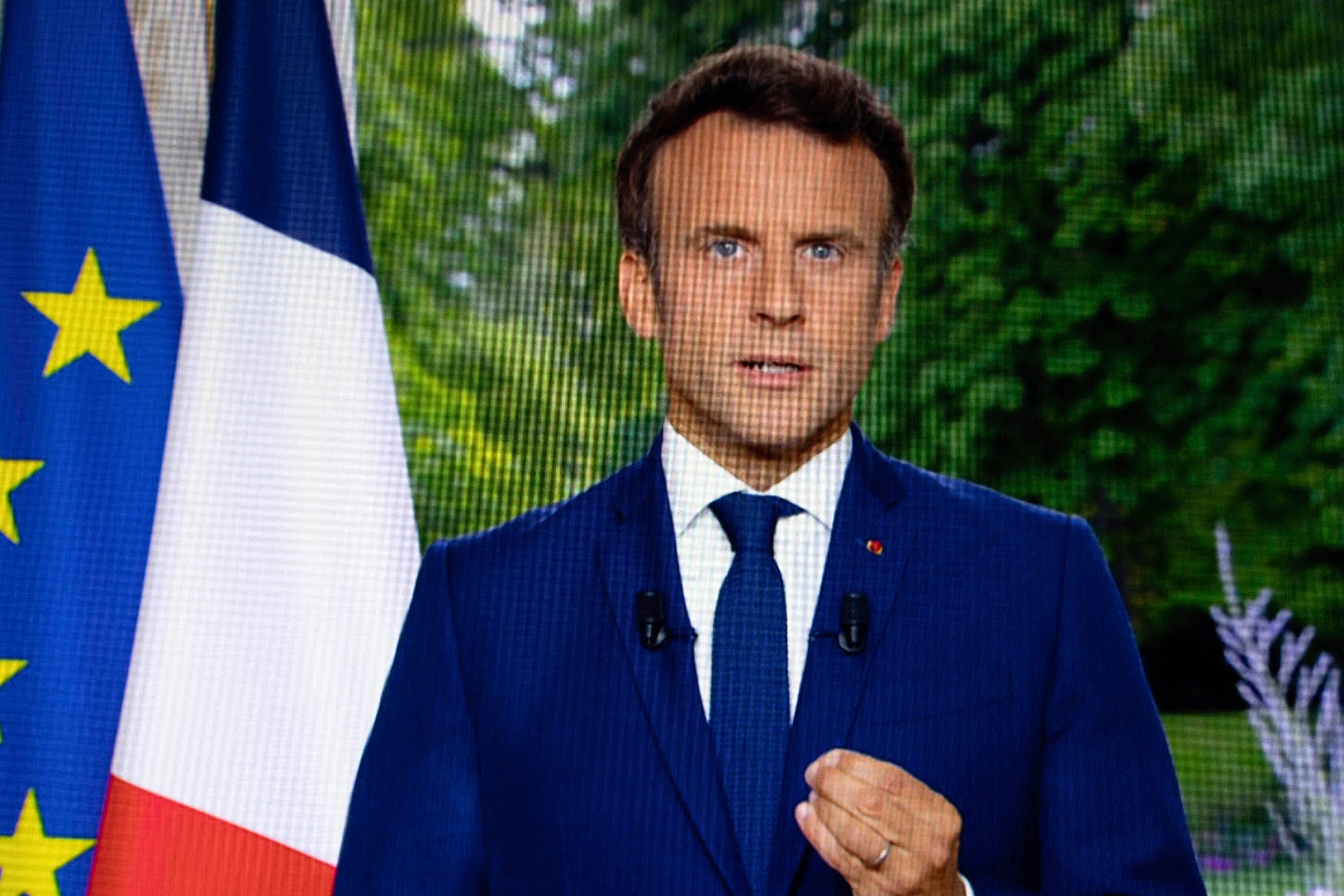 A photo of a TV screen shows French President Emmanuel Macron speaks during televised address on June 22, 2022, in Paris.