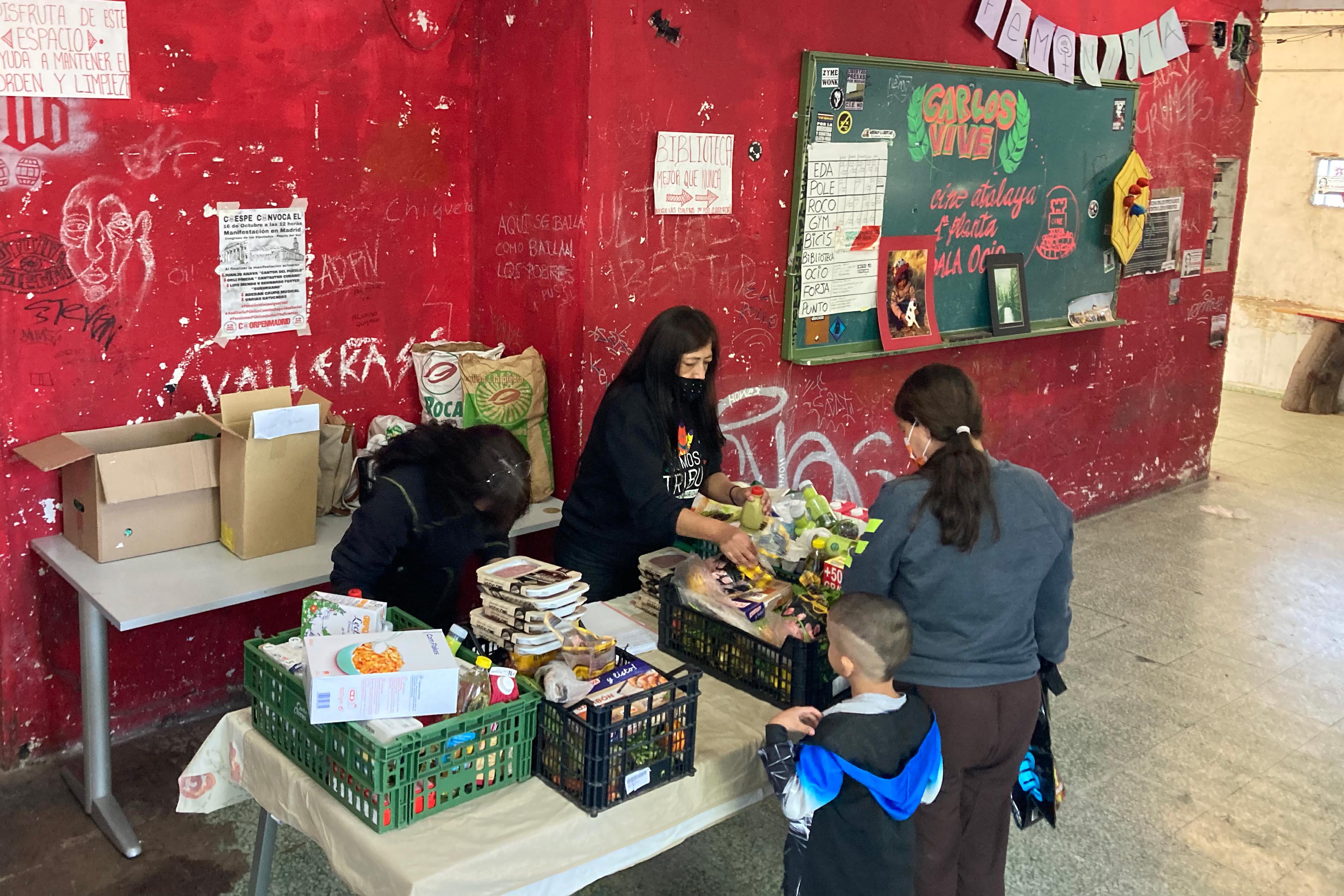 A woman and her son receive a fortnightly food distribution