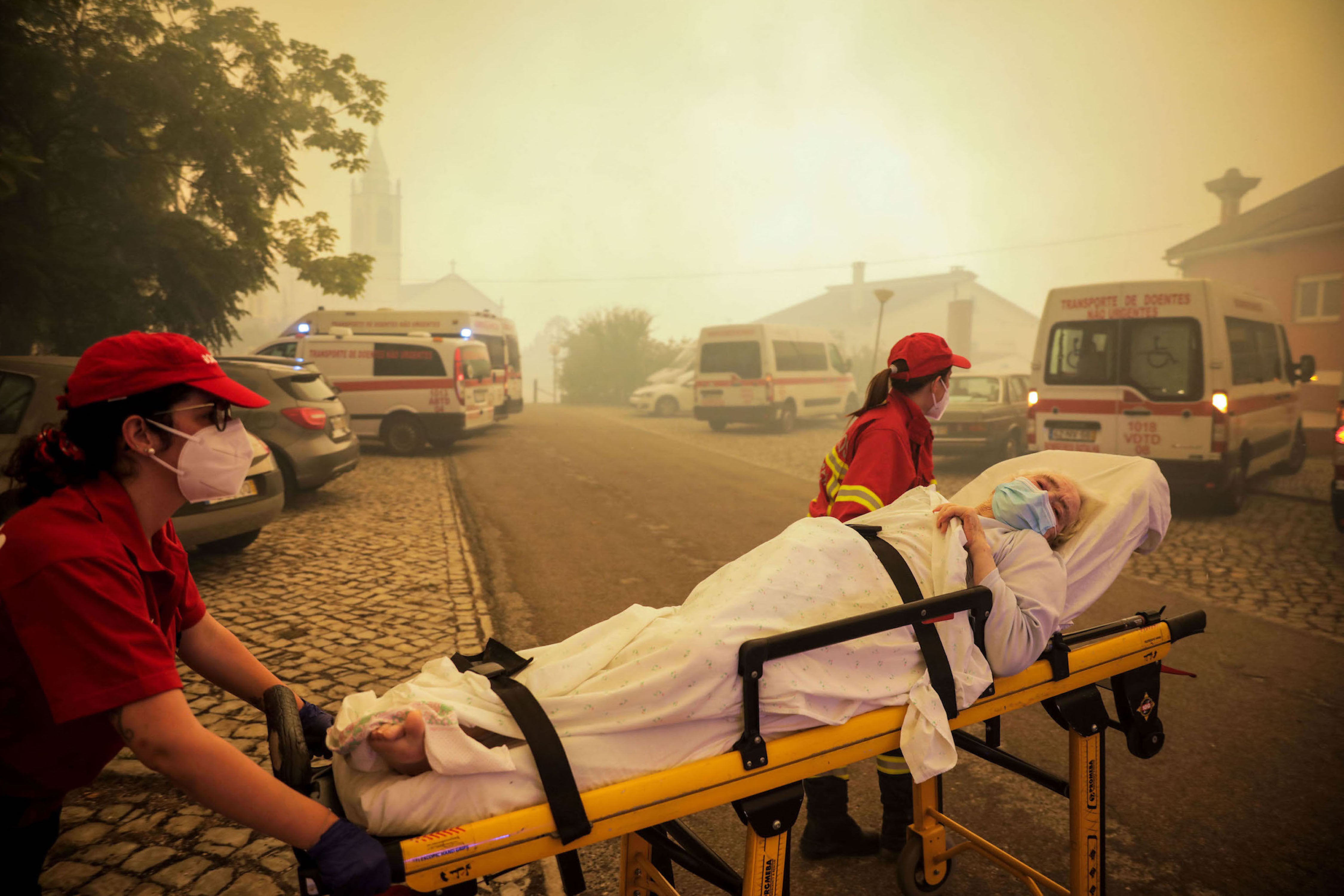 Firefighters evacuate elderly people from a nursing home in the village of Memoria, Portugal.