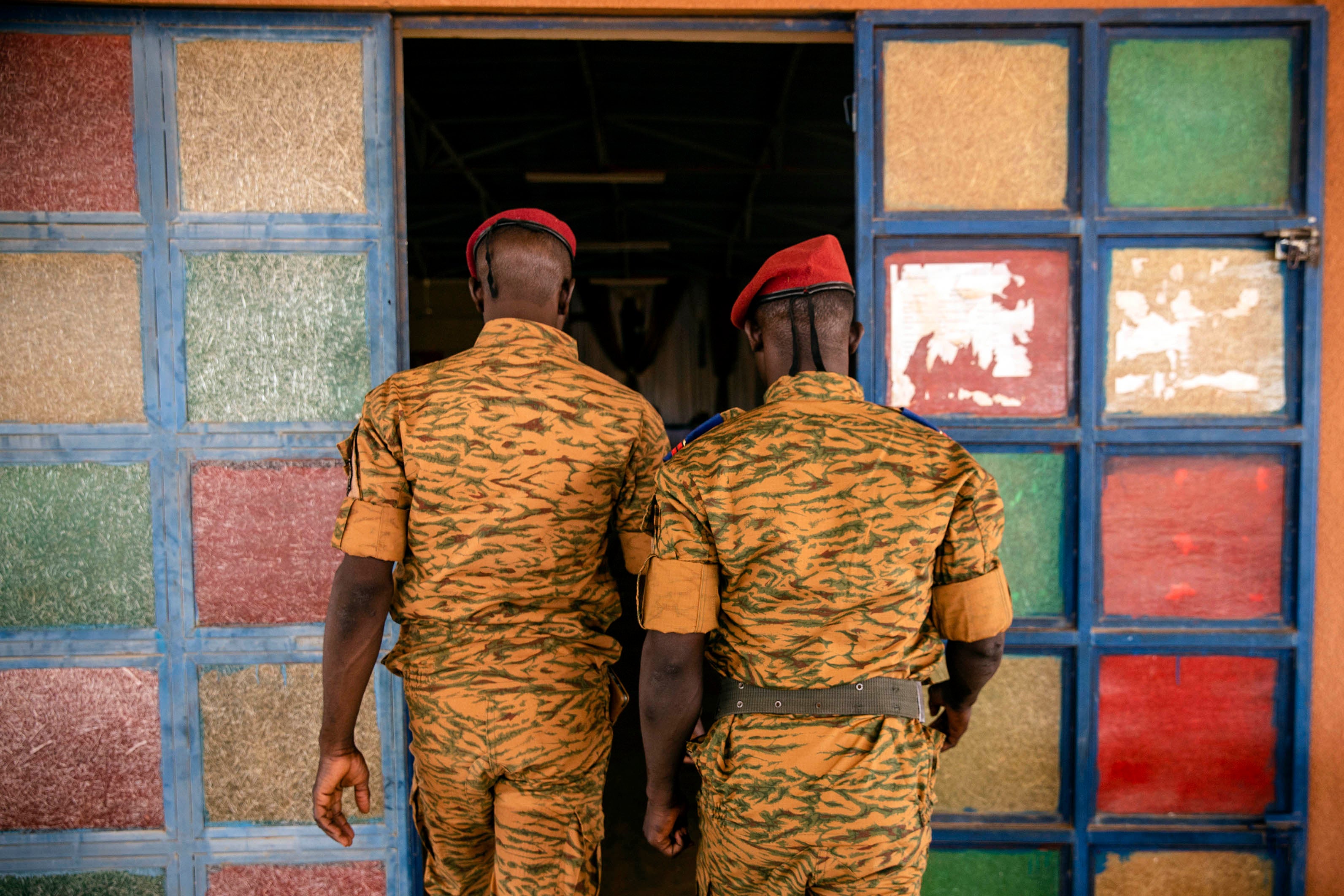 Two uniformed soldiers walk into a church