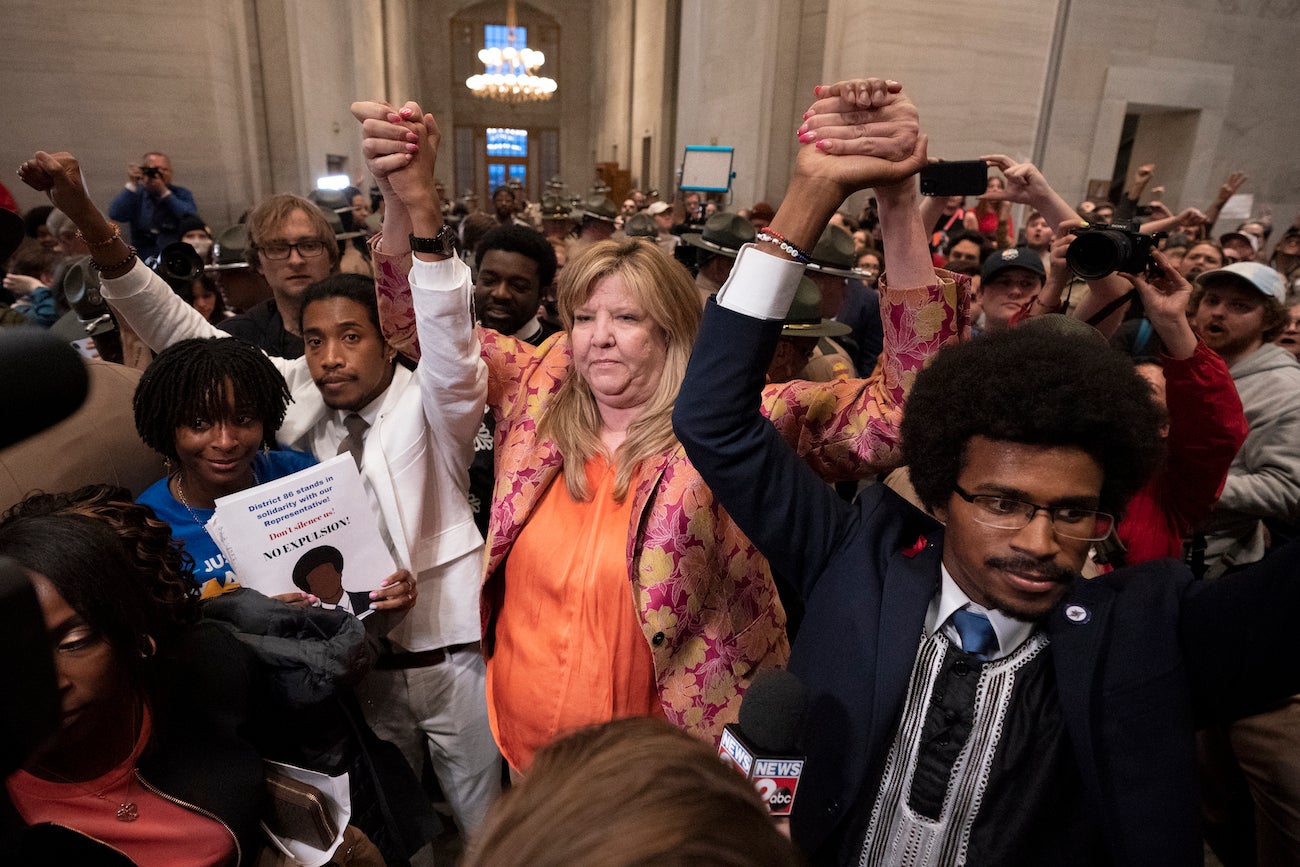 Former Rep. Justin Jones, D-Nashville, Rep. Gloria Johnson, D-Knoxville, and former Rep. Justin Pearson, D-Memphis, raise their hands outside the House chamber after Jones and Pearson were expelled from the legislature April 6, 2023.