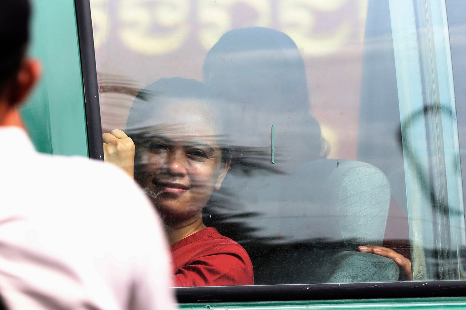 NagaWorld's union leader, Chhim Sithar, sits in a prisoner van outside the municipal court in Phnom Penh, Cambodia.