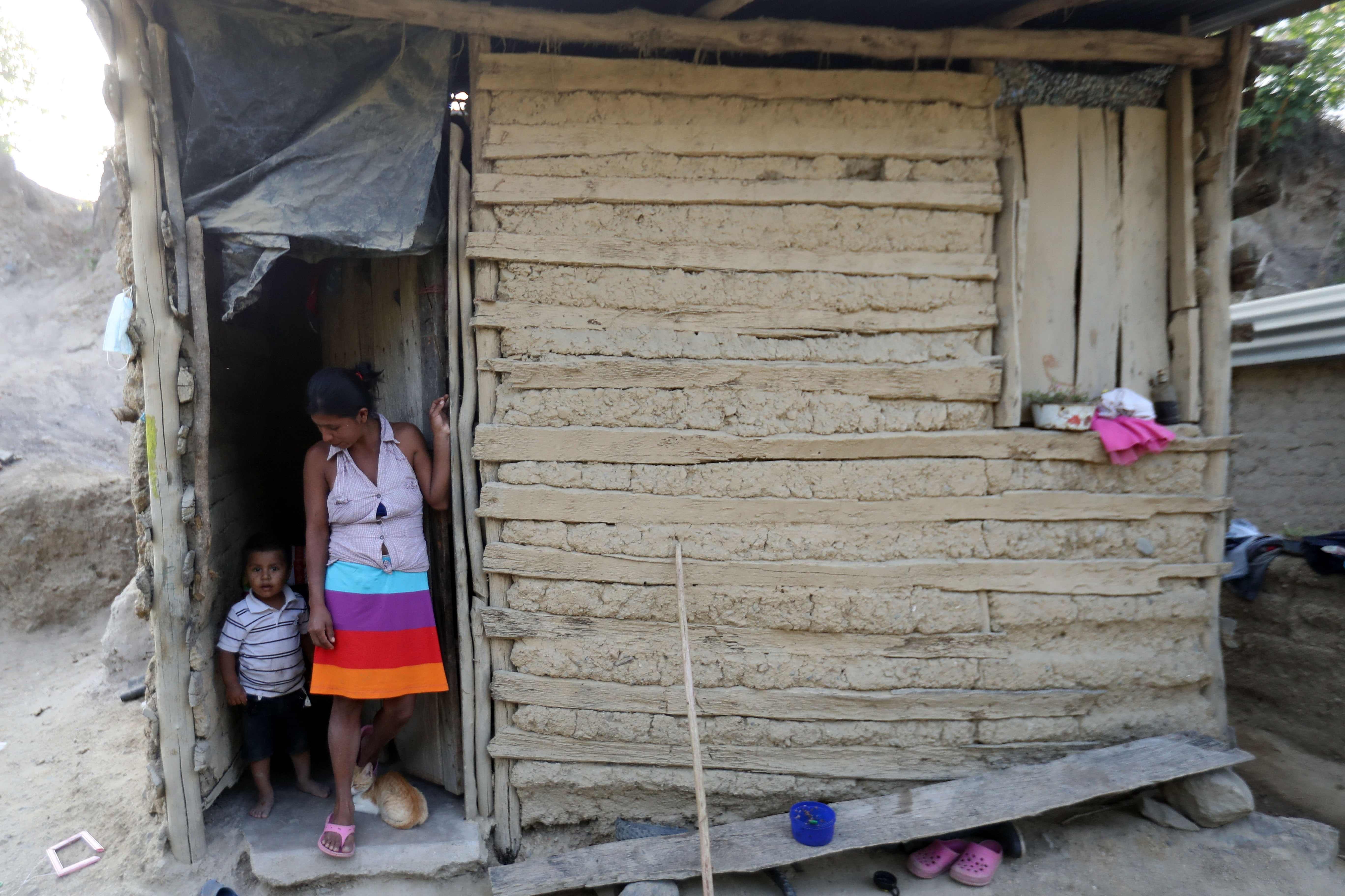 A woman and her son at their home in the community of El Redondo, municipality of Trojes, Honduras, April 28, 2021.