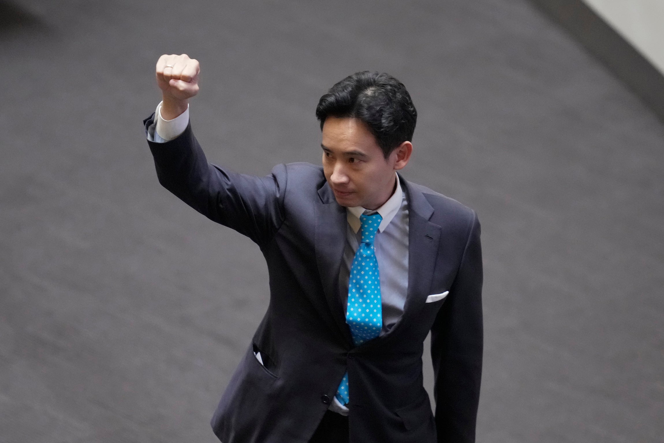 Pita Limjaroenrat, the leader of the Move Forward Party and top winner in May's general election, raises his hand as he leaves Parliament in Bangkok, Thailand, July 19, 2023.