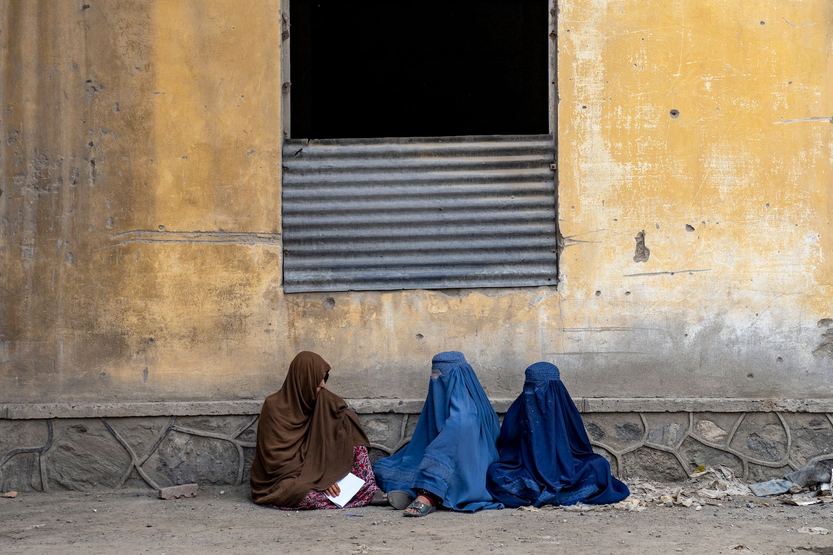 Afghan women wait to receive food rations distributed by a humanitarian aid group, Kabul, Afghanistan, May 23, 2023. 
