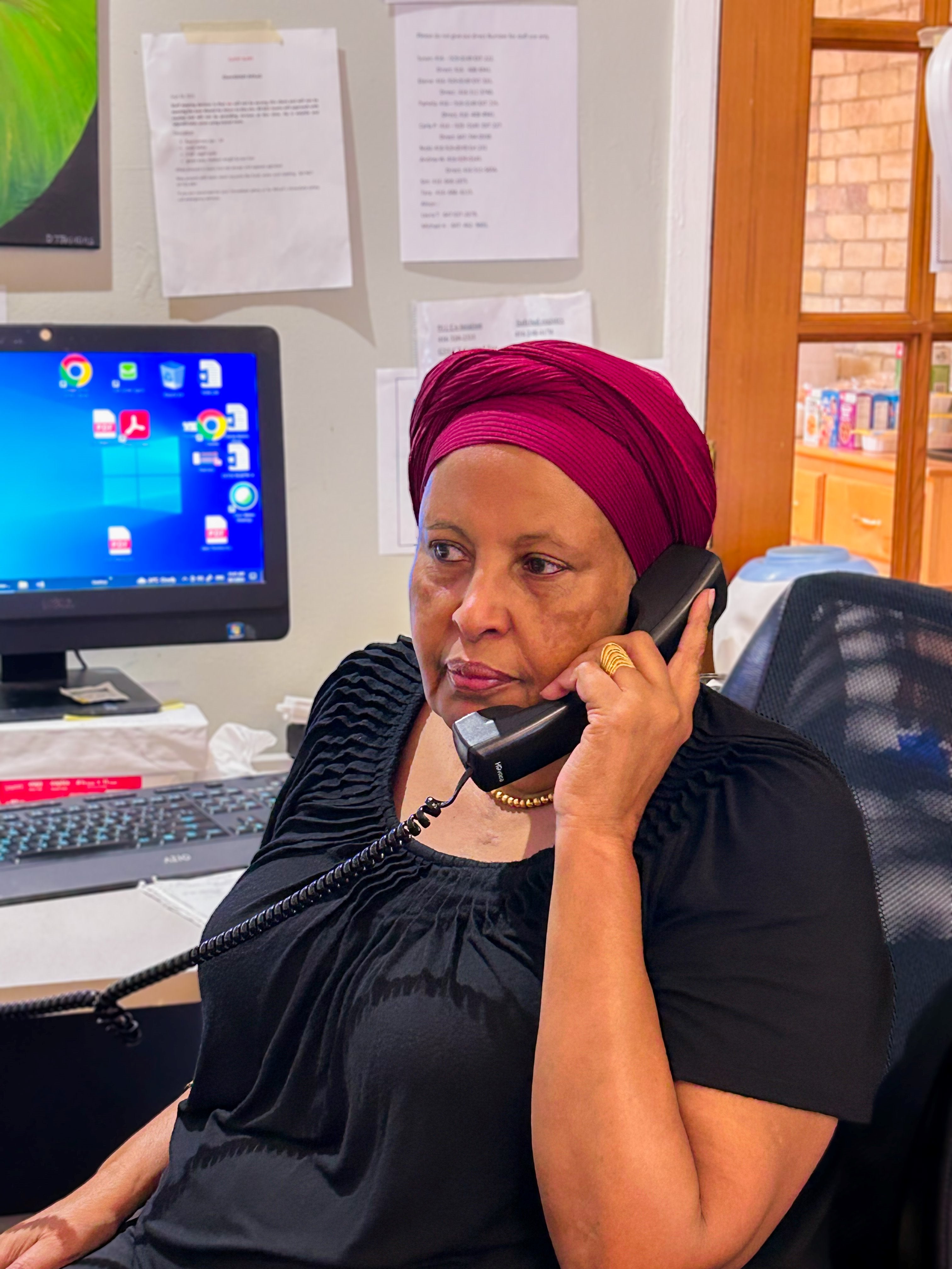 A woman speaks to a caller on the crisis line