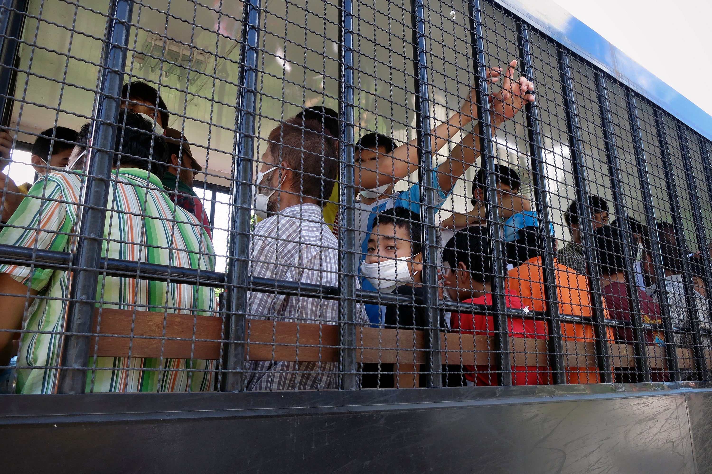 Suspected Uyghurs are transported back to a detention facility in the town of Songkhla in southern Thailand, March 26, 2014.
