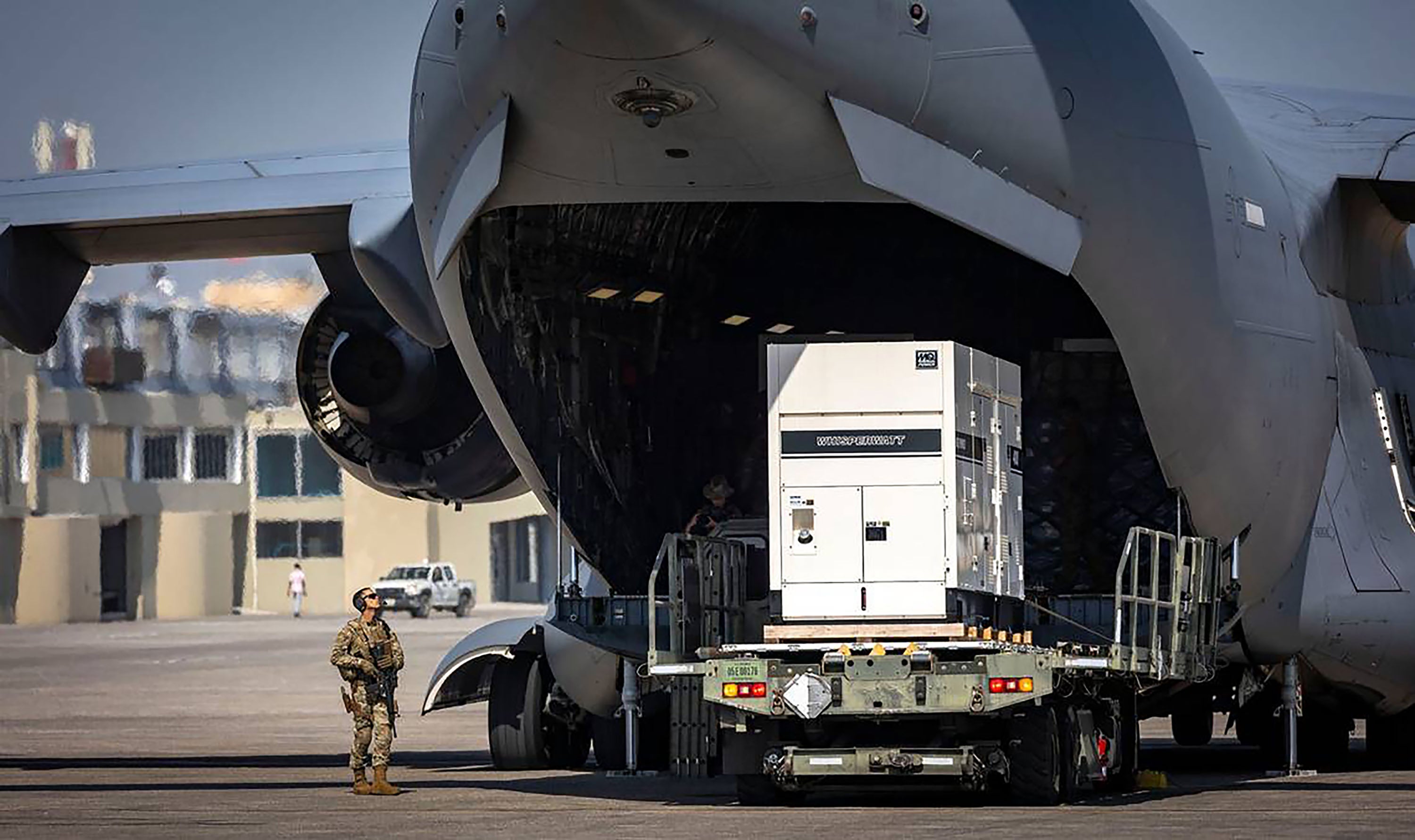 Supplies are offloaded from a U.S. Air Force C-17 cargo plane on the tarmac at Toussaint Louverture International Airport in Port-au-Prince, Haiti. The plane was carrying supplies for the camp being built for Kenyan police officers who will lead a Multinational Security Support mission into Haiti, May 15, 2024. 