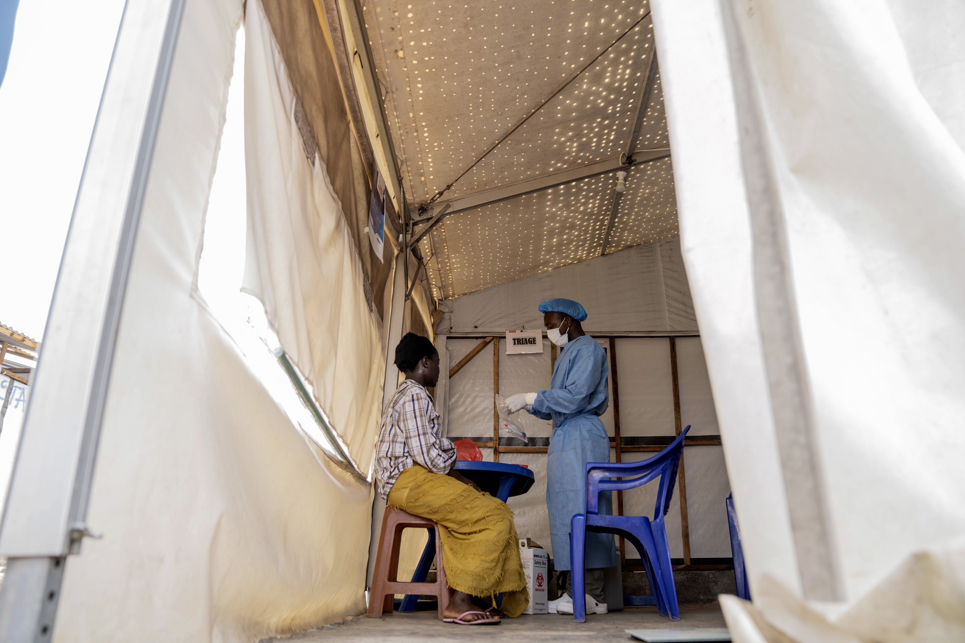 A health worker attends to an mpox patient at a treatment center in Munigi, eastern Democratic Republic of Congo, August 19, 2024. 
