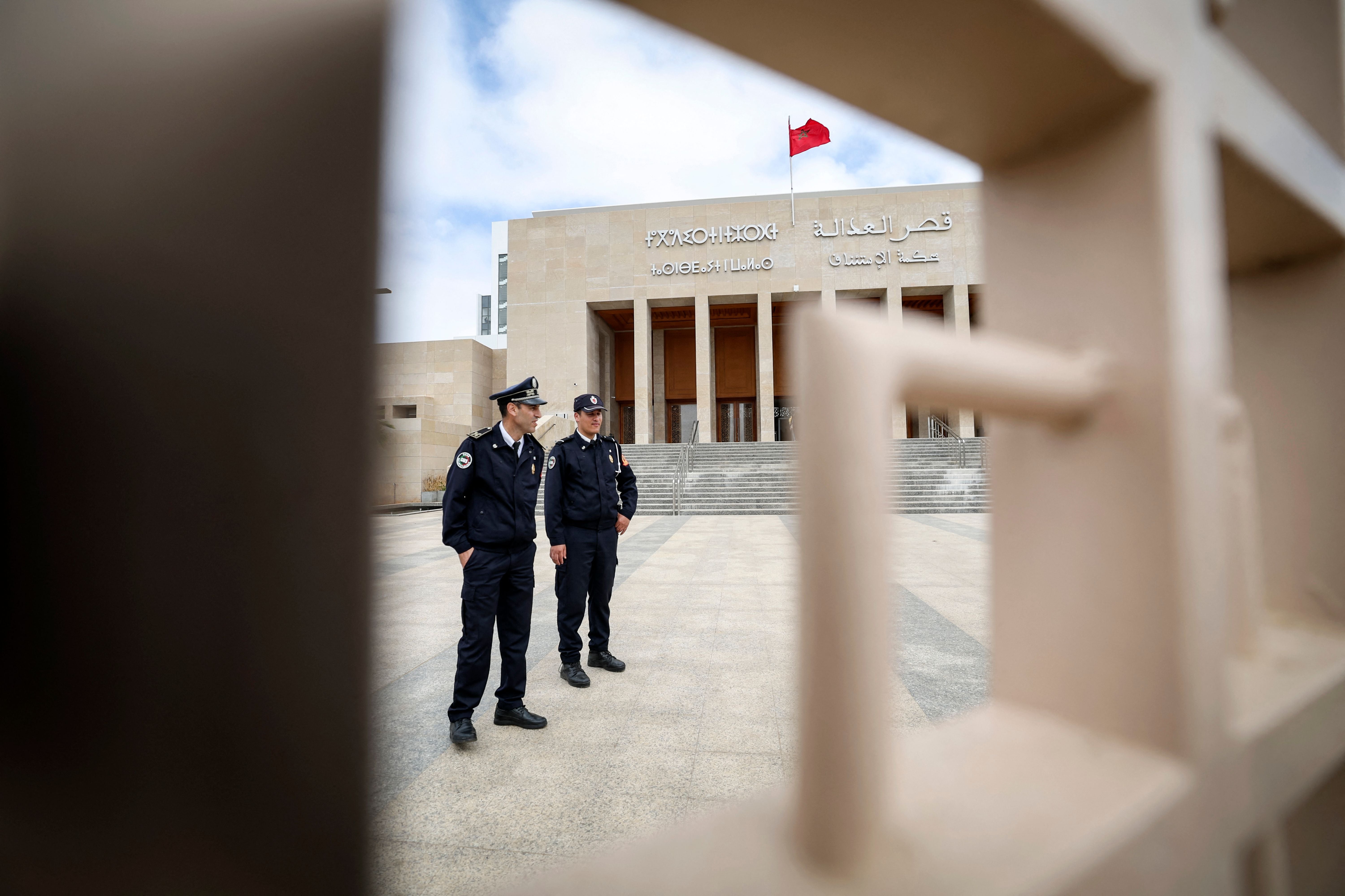 Moroccan policemen stand guard outside the tribunal of Rabat on April 13, 2023.