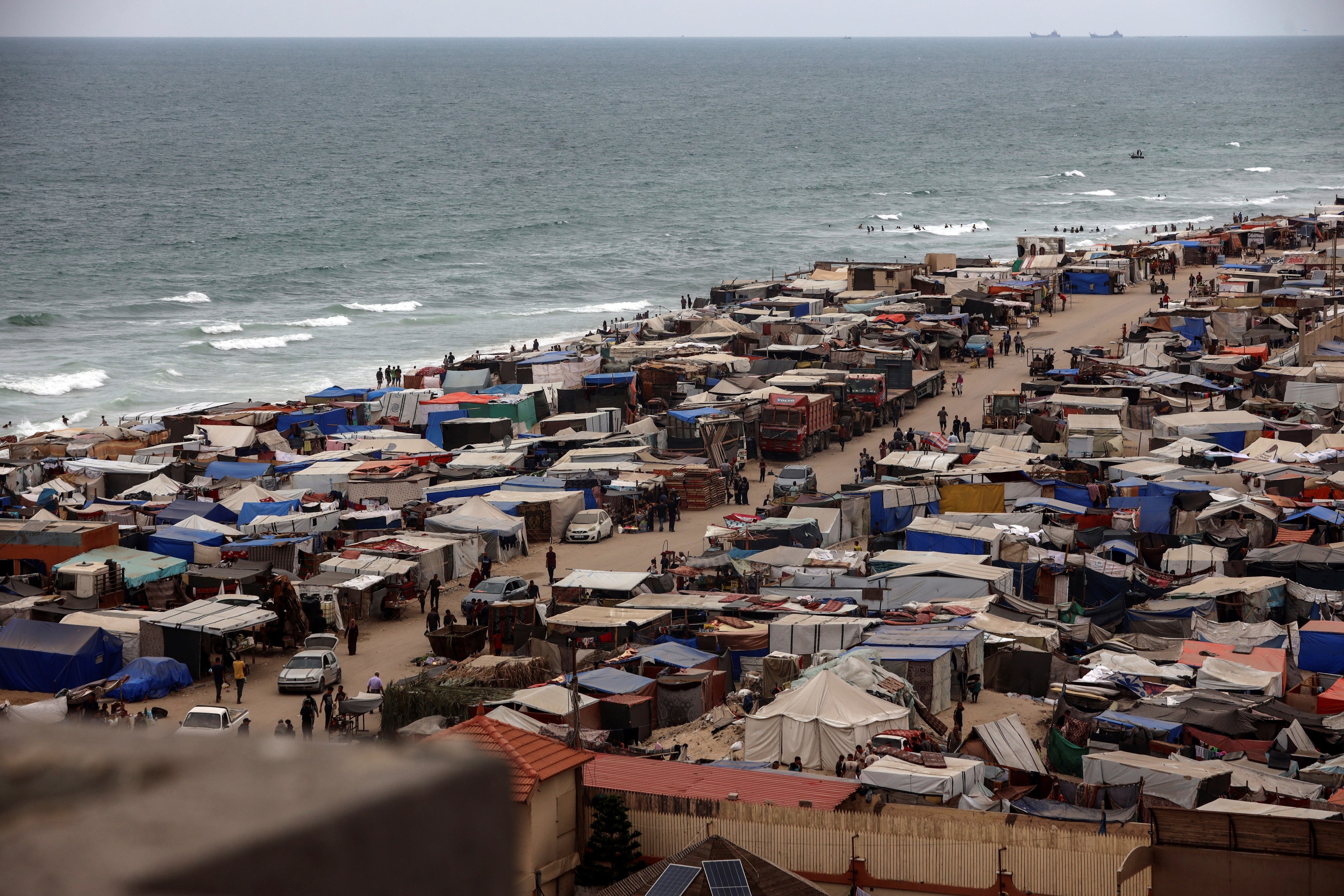 Tents housing internally displaced Palestinians crowding the beach and the Mediterranean shoreline