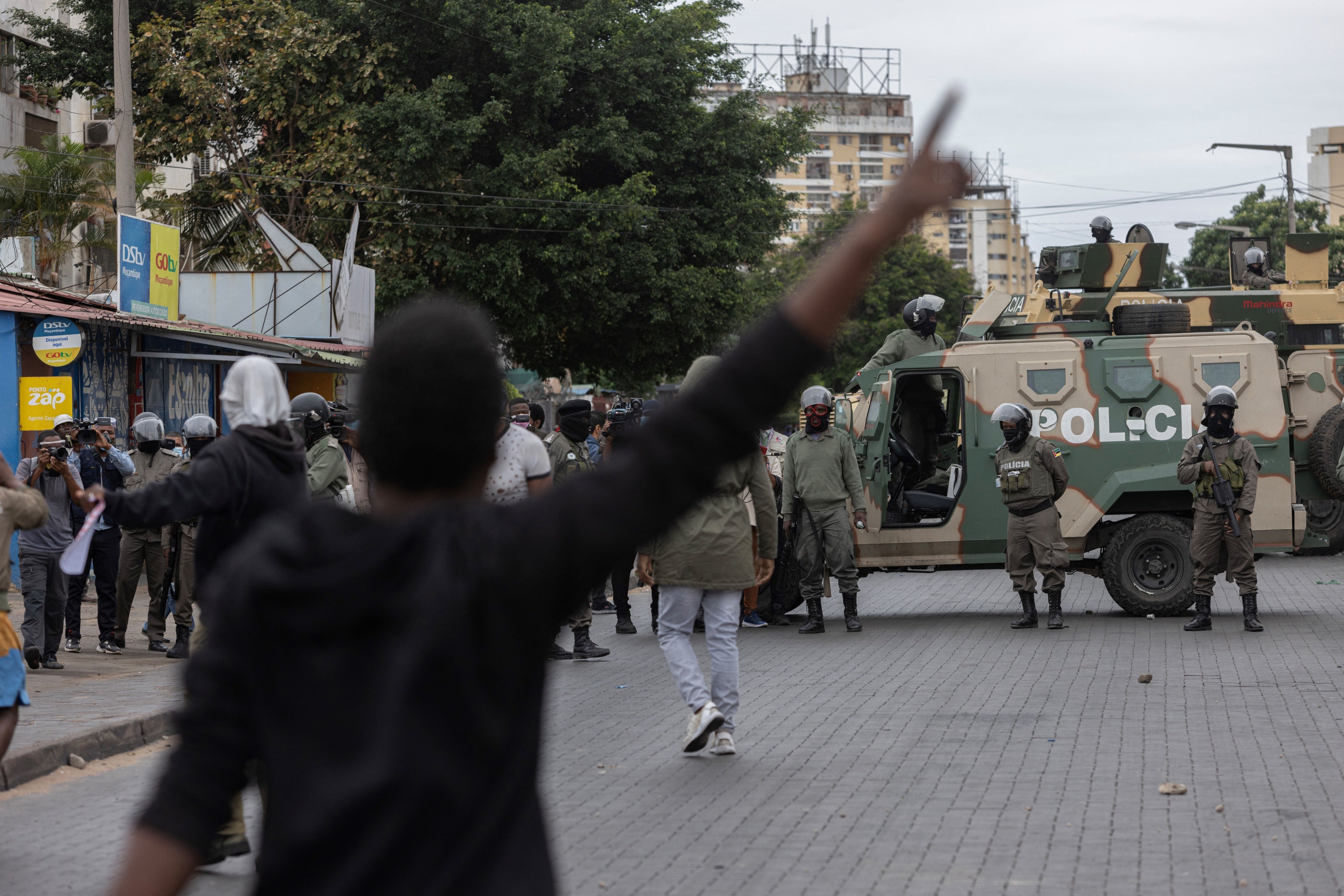 Riot police officers block a road
