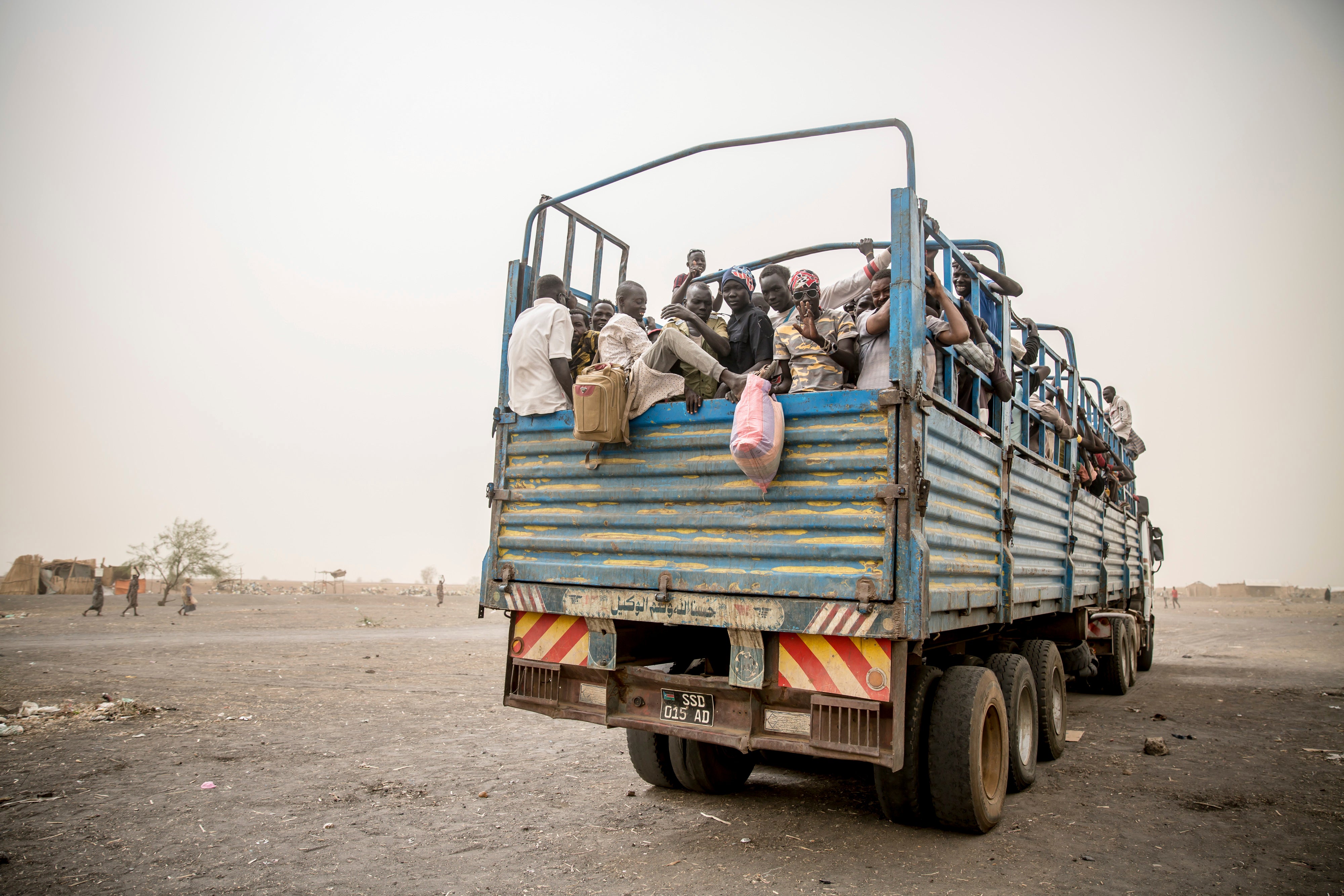 Refugees are taken in trucks