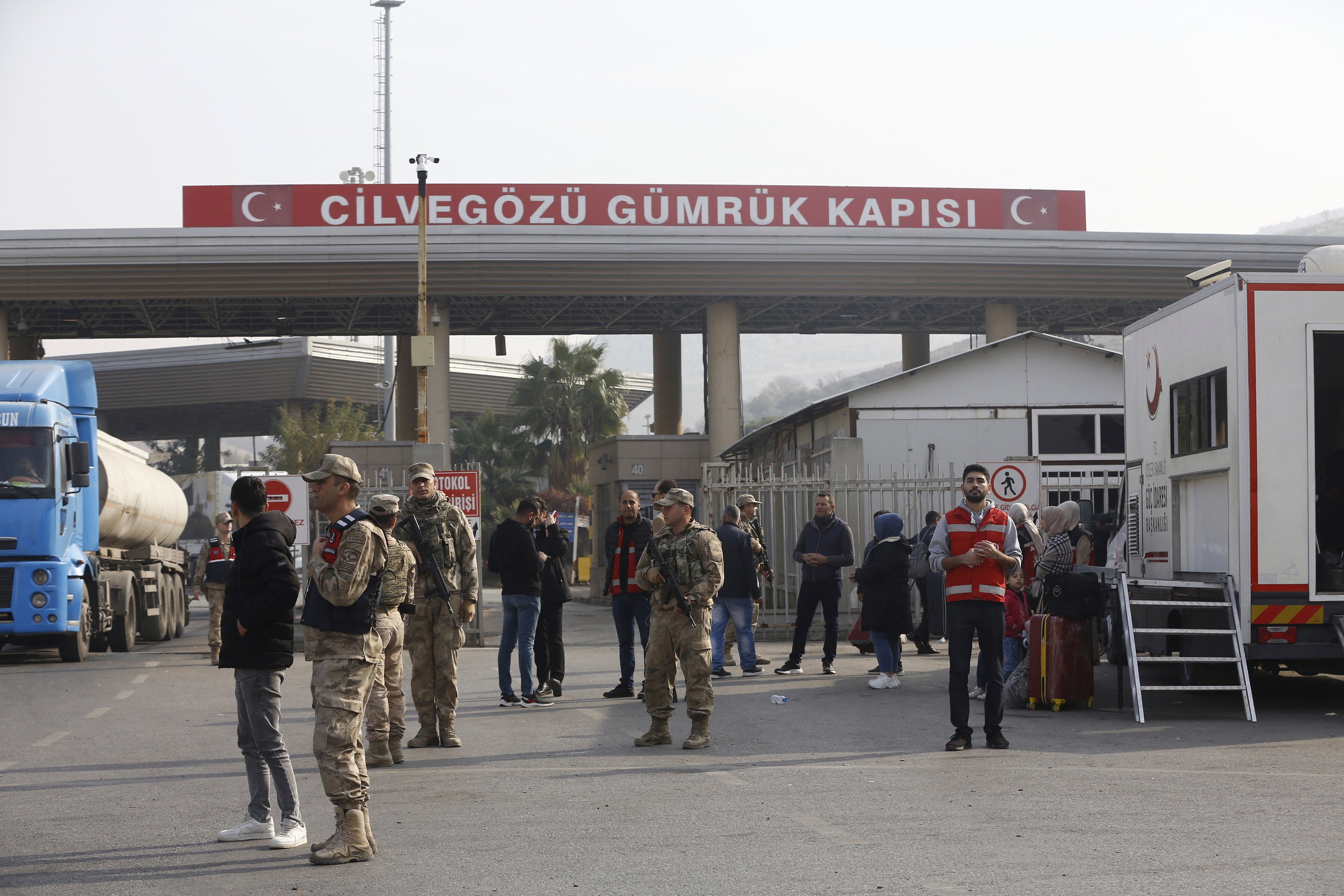 Syrian refugees in Turkey gather at Cilvegozu border gate on Turkish-Syrian border, after the fall of Assad regime in Syria, at Reyhanli district in Hatay, Turkey, December 10, 2024.