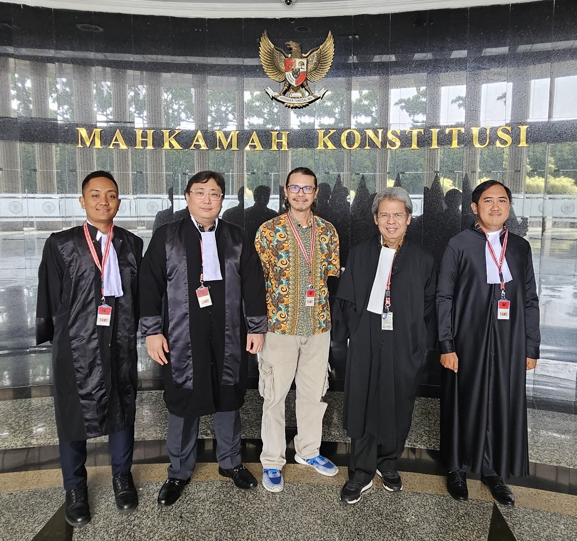 Daniel Tangkilisan (C), the environmentalist who filed the petition, and Todung Mulya Lubis (L-C) and other lawyers from the LSM law firm, at Indonesia’s Constitutional Court in Jakarta, April 29, 2025.