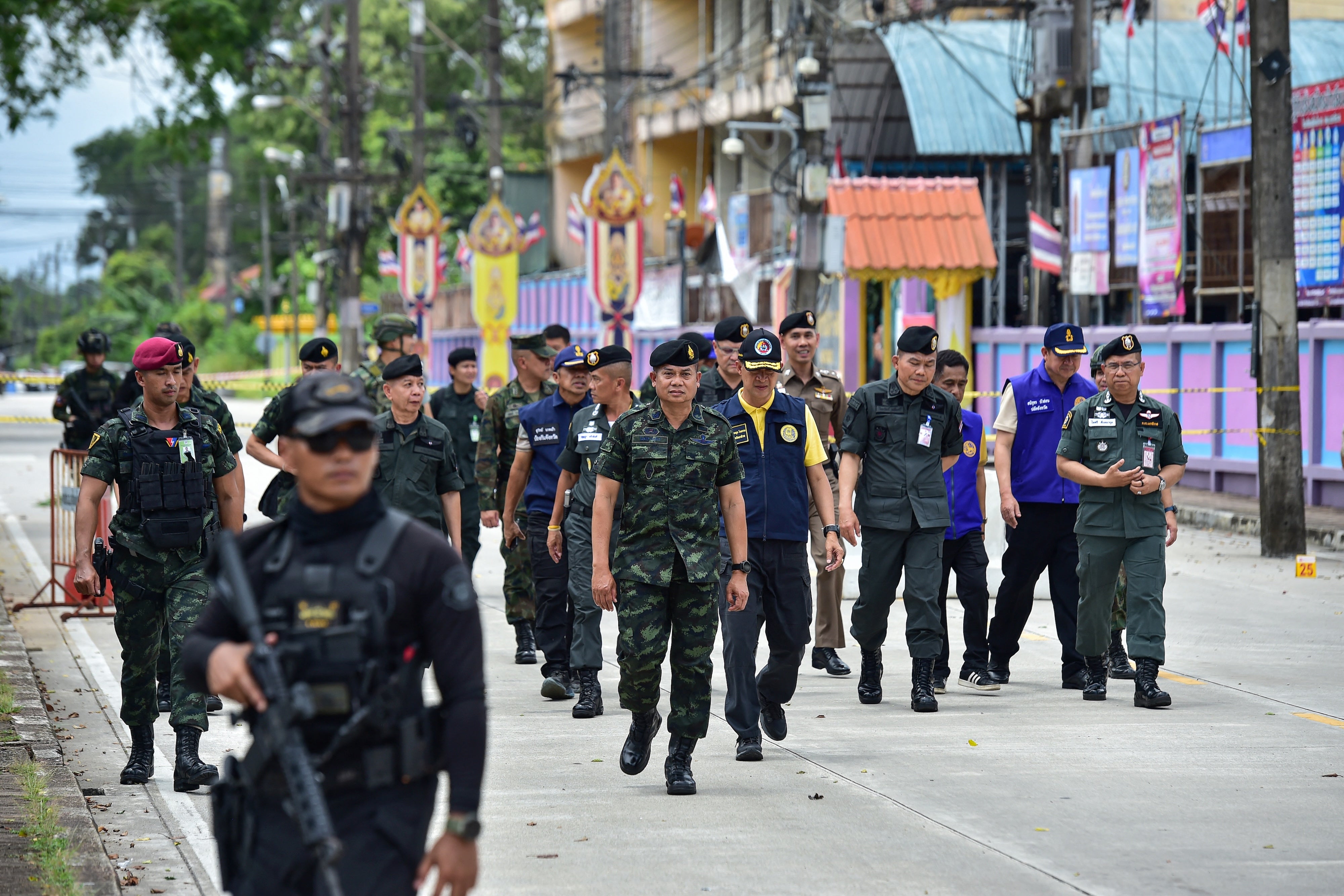 Thailand's commander of the 4th Army Region Lt. Gen. Paisan Nusang (C) and officials inspect the site of an insurgent attack outside the district office of Sungai Kolok in the southern Thailand province of Narathiwat on March 9, 2025. 
