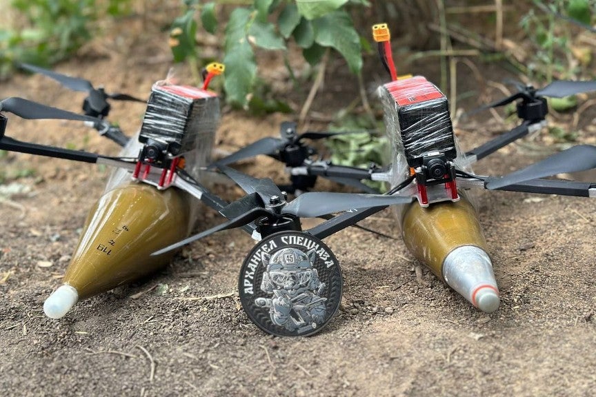 two VT-40 drones with a munition taped to each of the airframes
