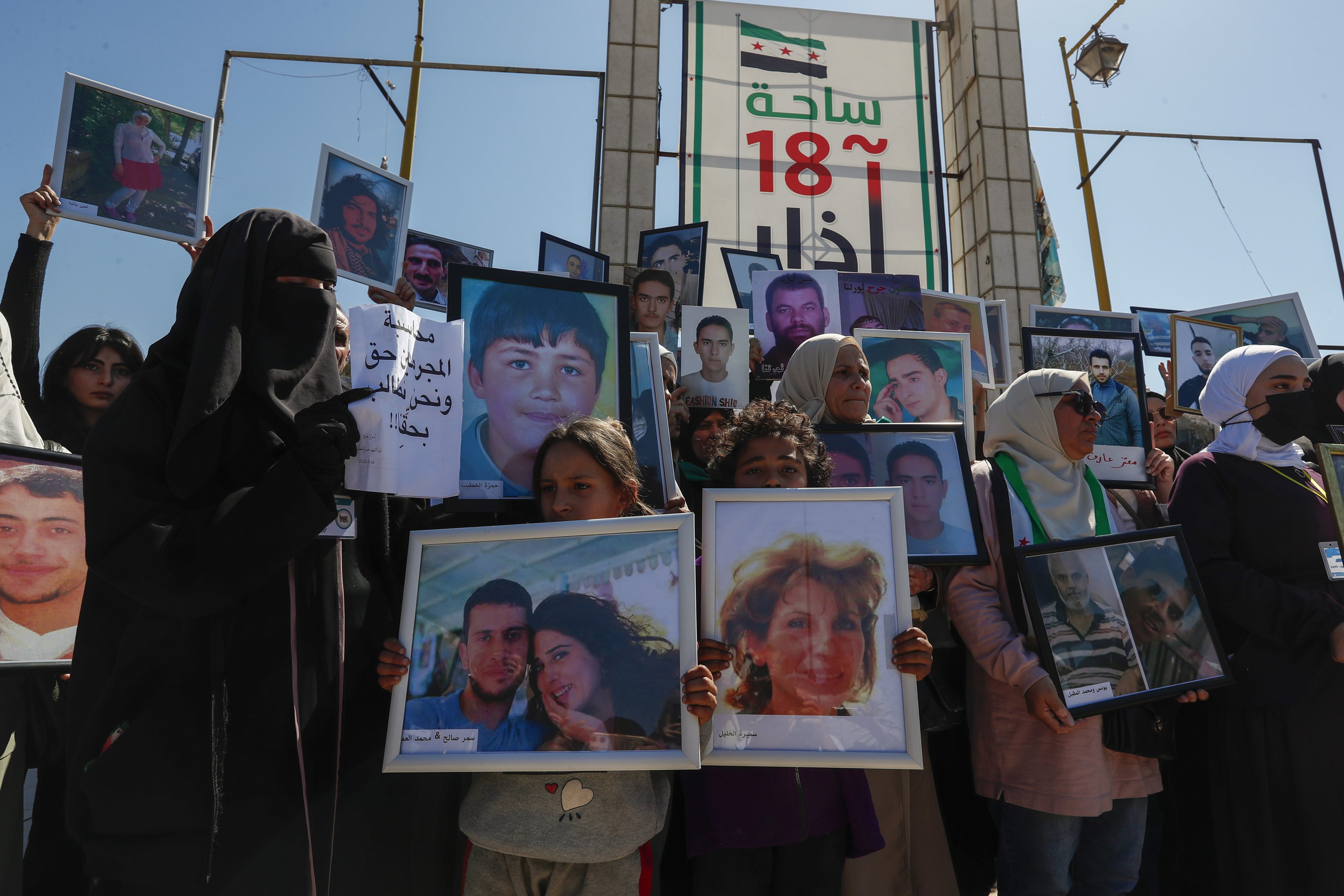 Family members hold pictures of their relatives who disappeared in the nearly 14-year Syrian conflict, during a protest calling on the interim government to not give up on efforts to find them, in the city of Daraa, Syria, March 16, 2025. 