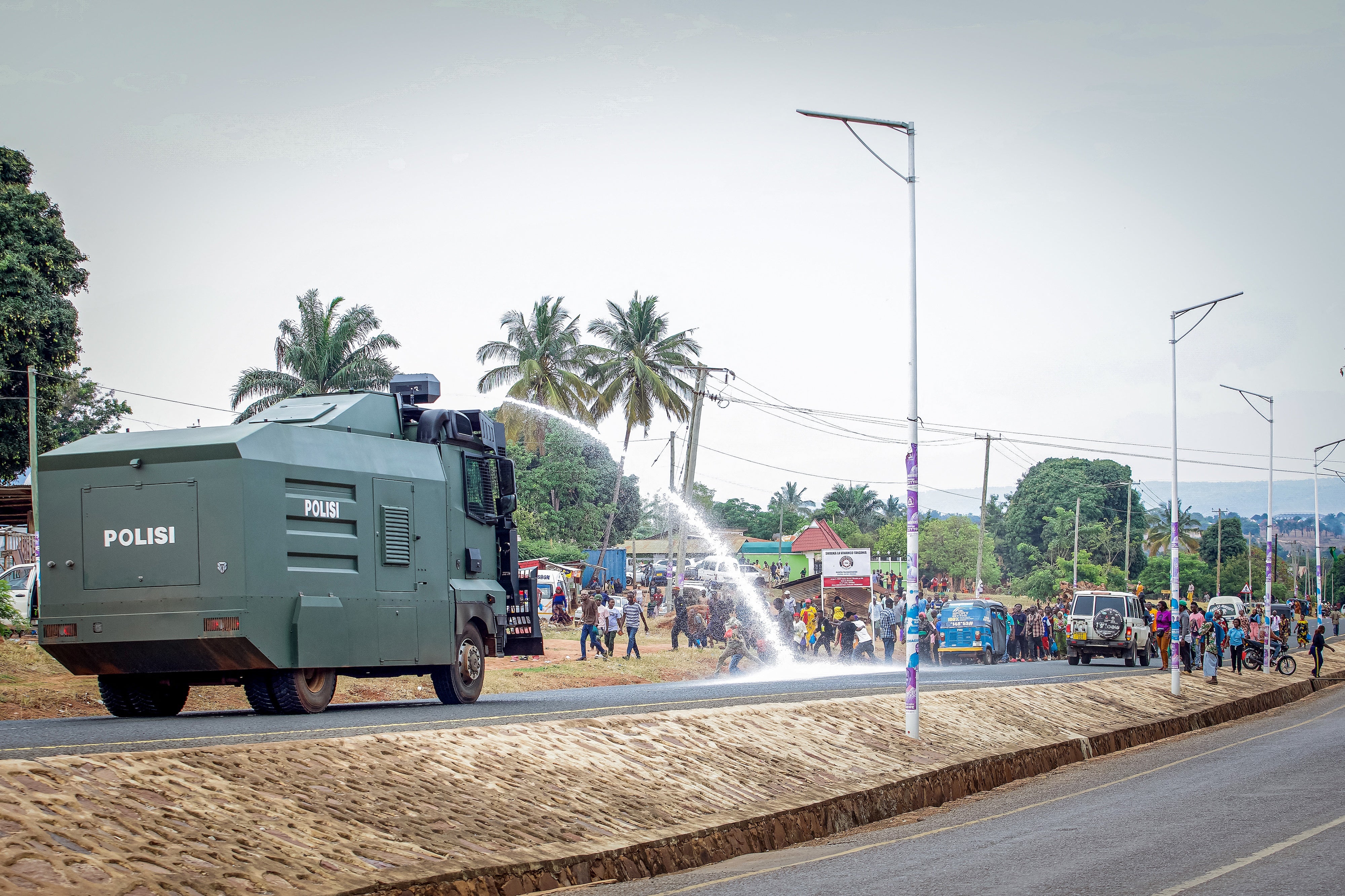 A Tanzanian police water cannon shoots water at opposition party supporters during a protest in Kigoma, Tanzania, on October 30, 2025, a day after Tanzania's presidential and legislative elections.
