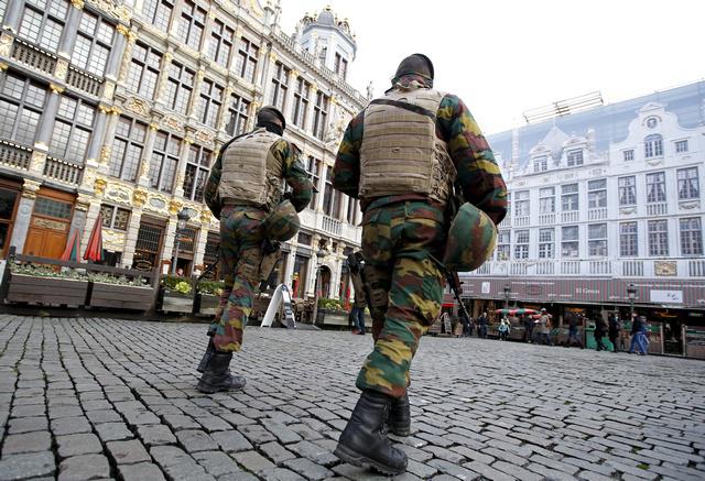 Belgian soldiers patrol the Grand Place in central Brussels after security was tightened in Belgium following the terrorist attacks in Paris, France.