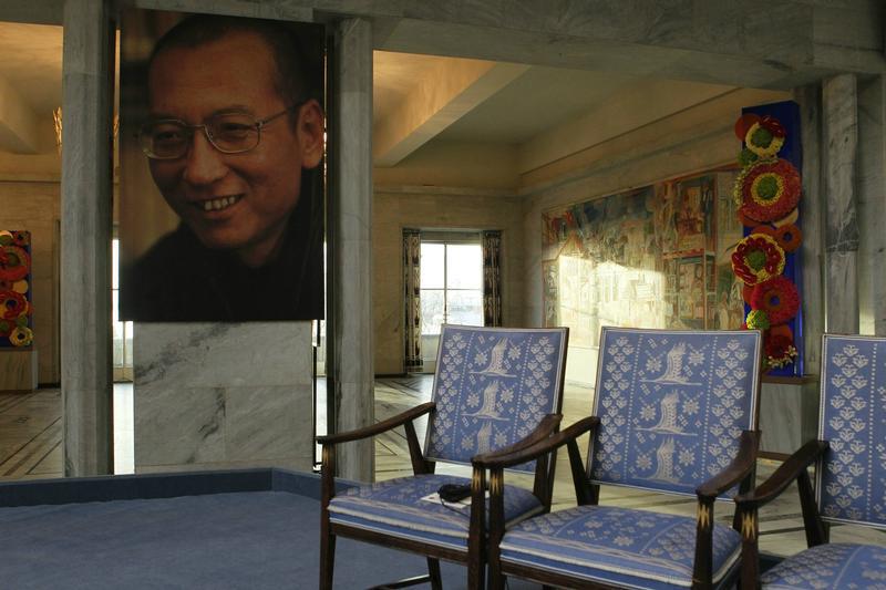A picture of this year's Nobel Peace Prize laureate jailed Chinese dissident Liu Xiaobo is seen near an empty chair where he would have sat, during the Nobel Peace Prize ceremony at Oslo City Hall December 10, 2010. 