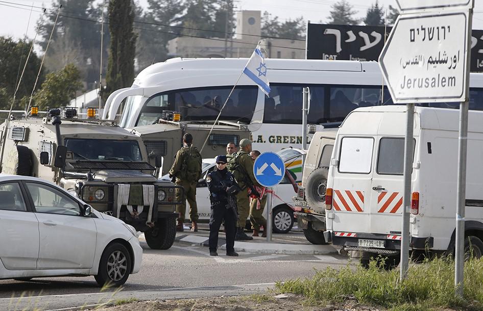 Israeli security forces inspect the scene where a Palestinian, who the Israeli military said tried to stab soldiers, was shot dead at Gush Etzion junction, south of the West Bank city of Bethlehem on March 18, 2016. © 2016 Reuters